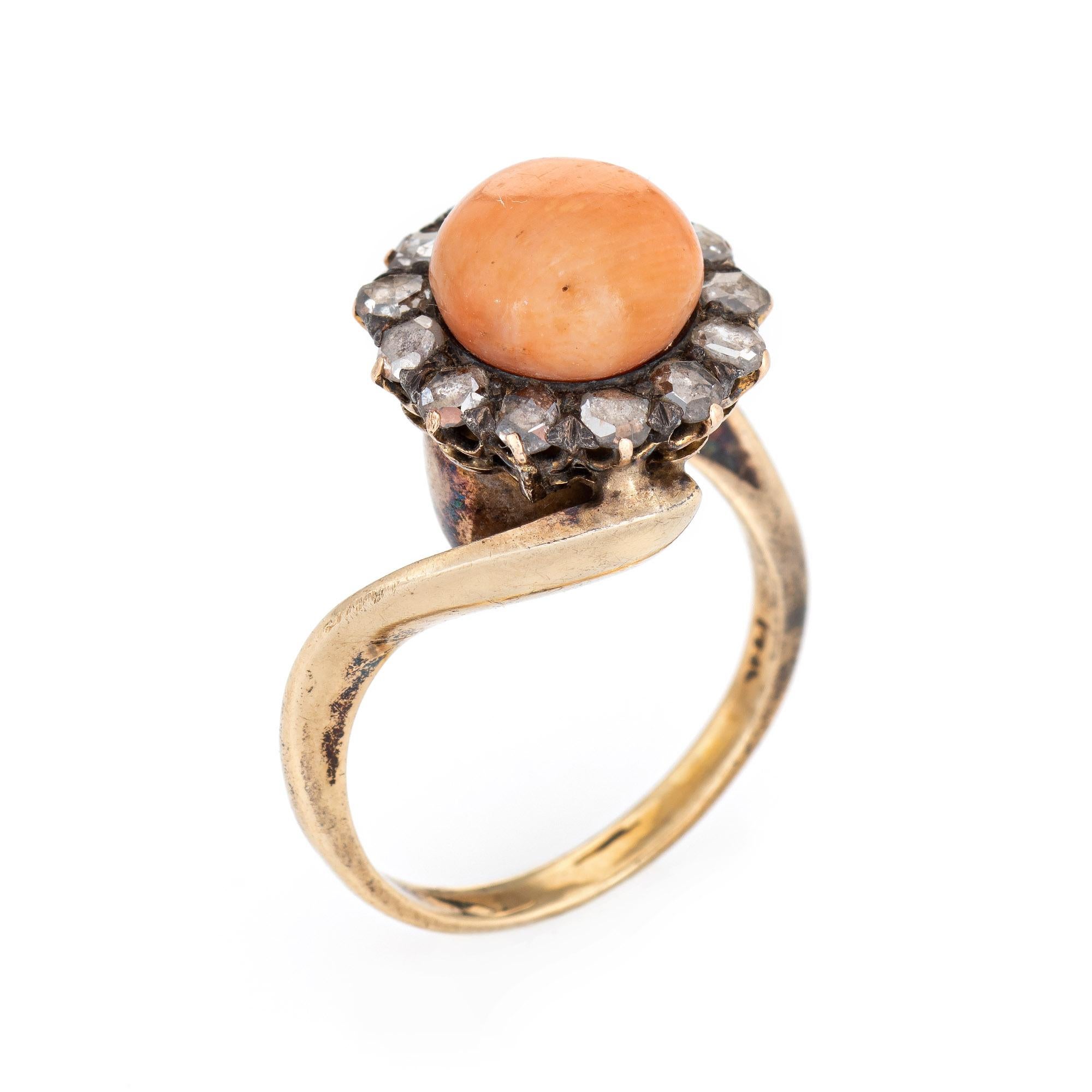 Stylish vintage coral ring (circa 1880s to 1900s) crafted in 14 karat yellow gold. 

Cabochon cut coral measures 9mm, accented with 13 estimated 0.05 carat old rose cut diamonds. The total diamond weight is estimated 0.65 carats (estimated at K-L