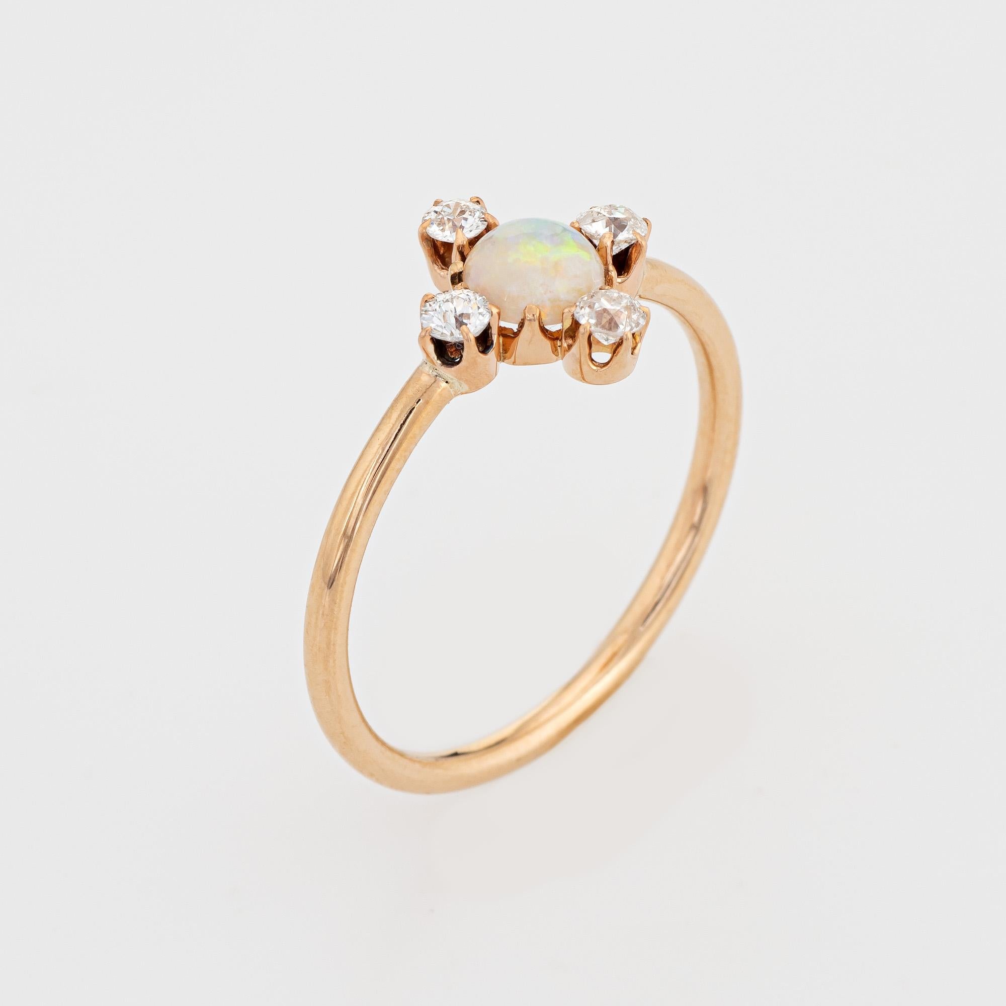 Originally an antique Victorian era stick pin (circa 1880s to 1900s), the opal & diamond ring is crafted in 14 karat yellow gold.

The ring is mounted with the original stick pin. Our jeweler rounded the stick pin into a slim band for the finger.