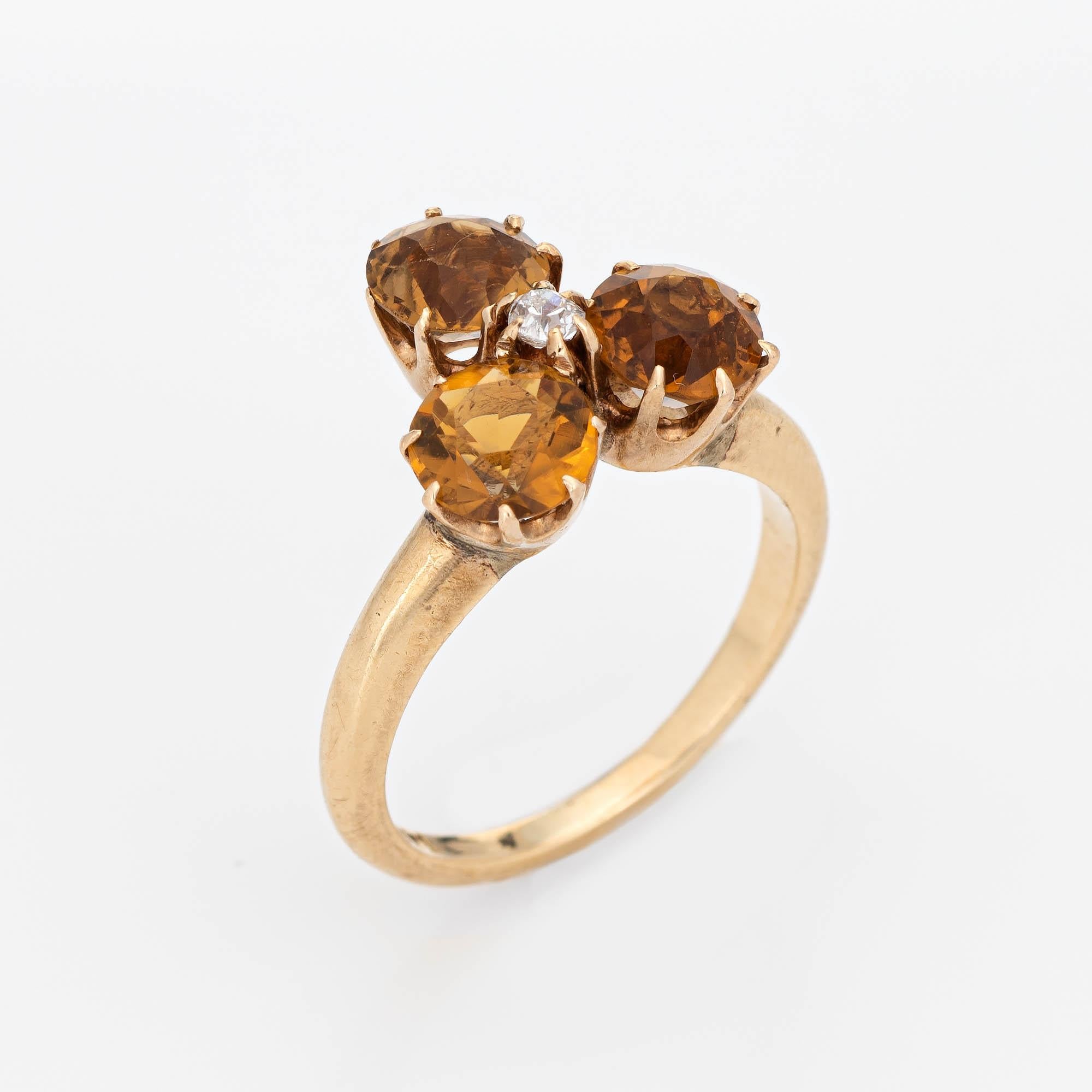 Finely detailed antique Victorian citrine & diamond trefoil ring (circa 1880s to 1900s) crafted in 14 karat yellow gold. 

Three estimated 0.40 carat citrines total an estimated 1.20 carats. The old mine cut diamond is estimated at 0.05 carats