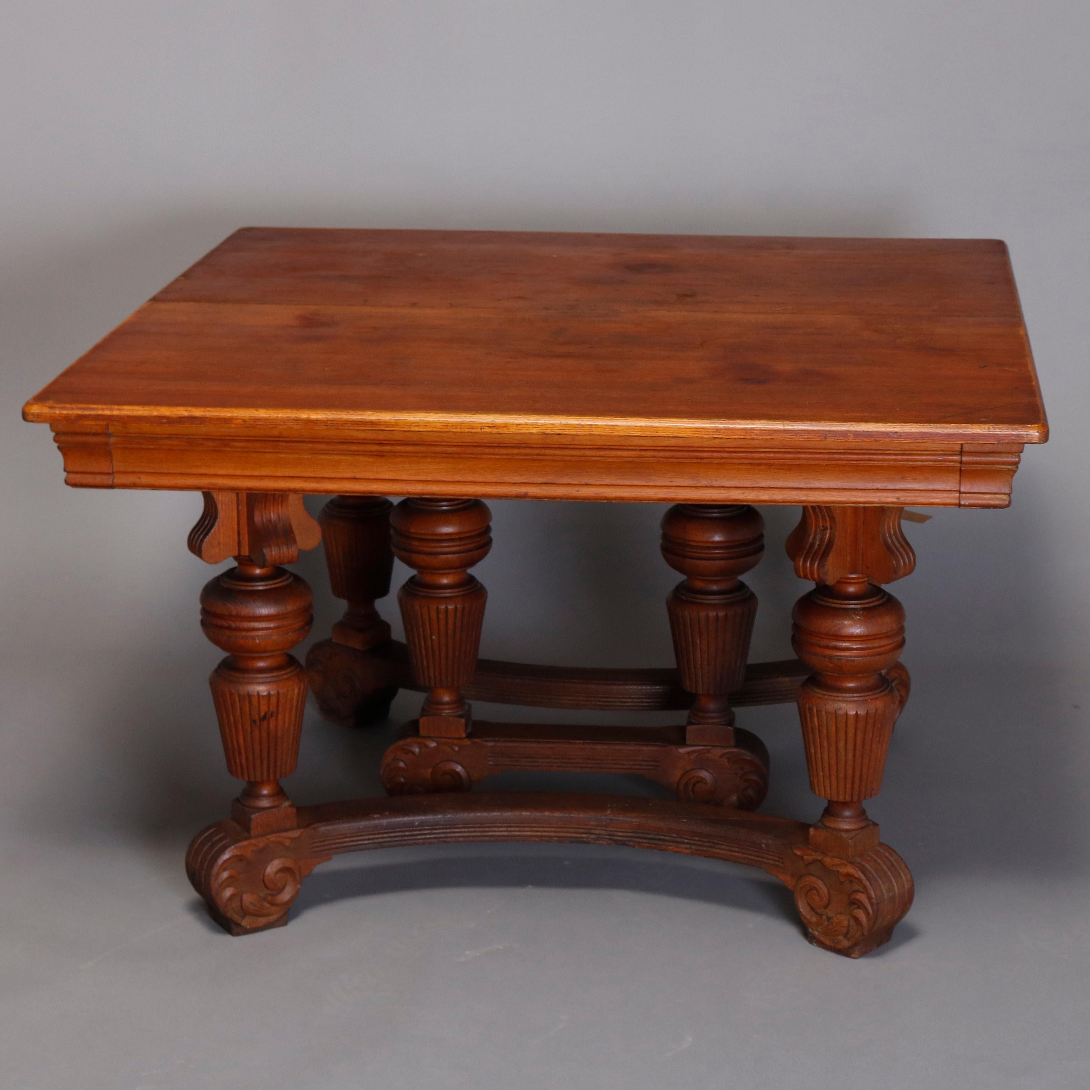 An antique Victorian R.J. Horner style dining table offers oak construction with oversized carved baluster legs having shaped ball and fluted flared form raised on convex stretchers having feet with carved scroll decoration, square dining table