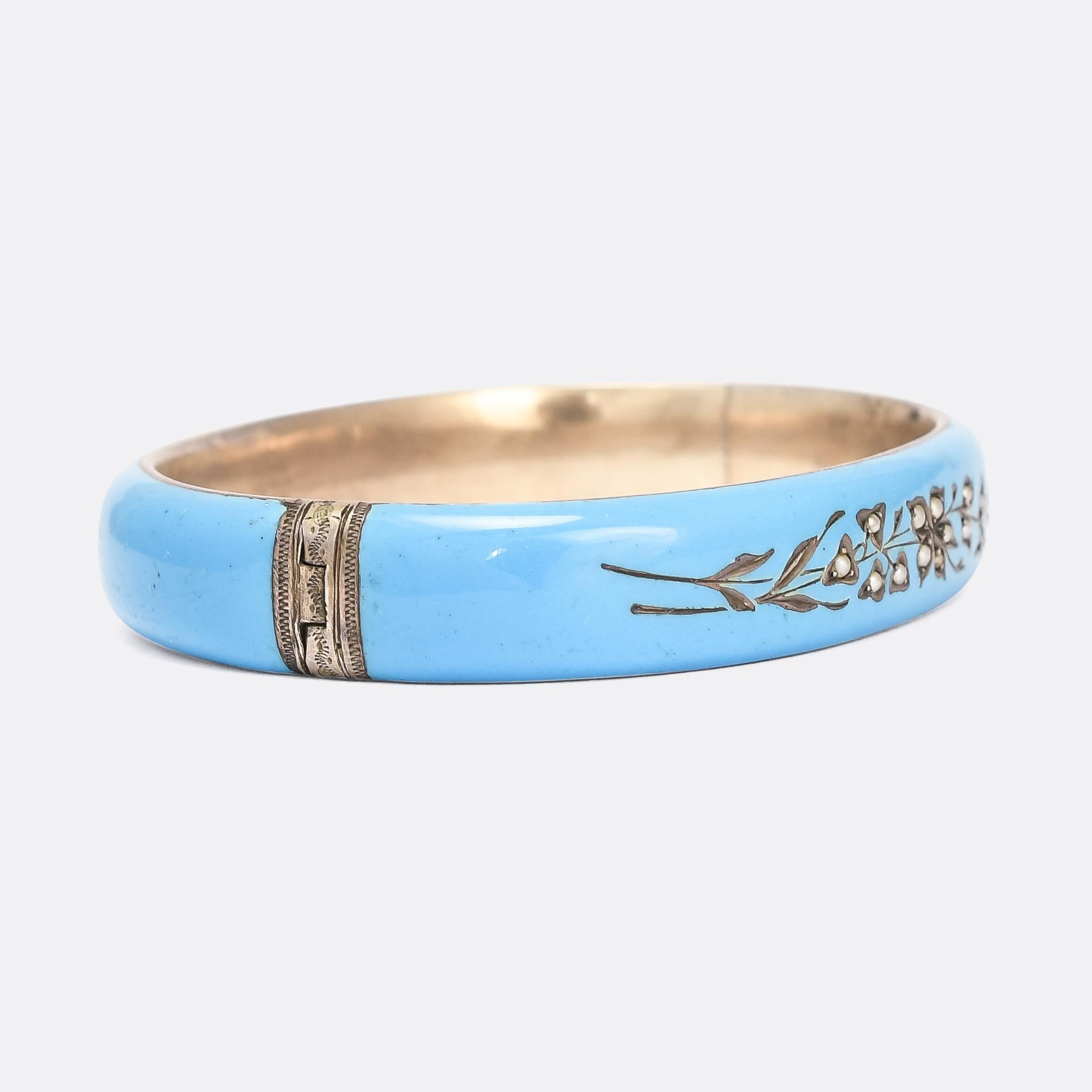 A striking robin's egg blue enamelled bangle dating from the latter half of the 19th Century. The front is set with pearls within a floral scene, and it bears Austro-Hungarian silver marks. It's hinged on one side and has been made to fit up to a
