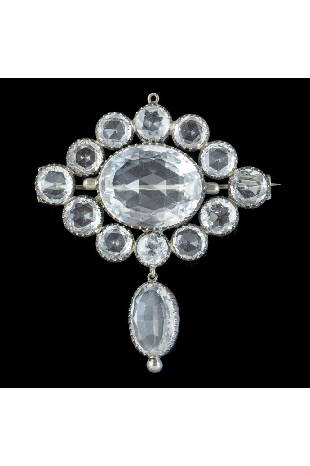 A magnificent Antique Victorian brooch fashioned in Silver and set with large, clear Rock Crystals which have been cut with many triangular facets which glisten beautifully when they catch the light. 

The beautiful clear Rock crystal is a