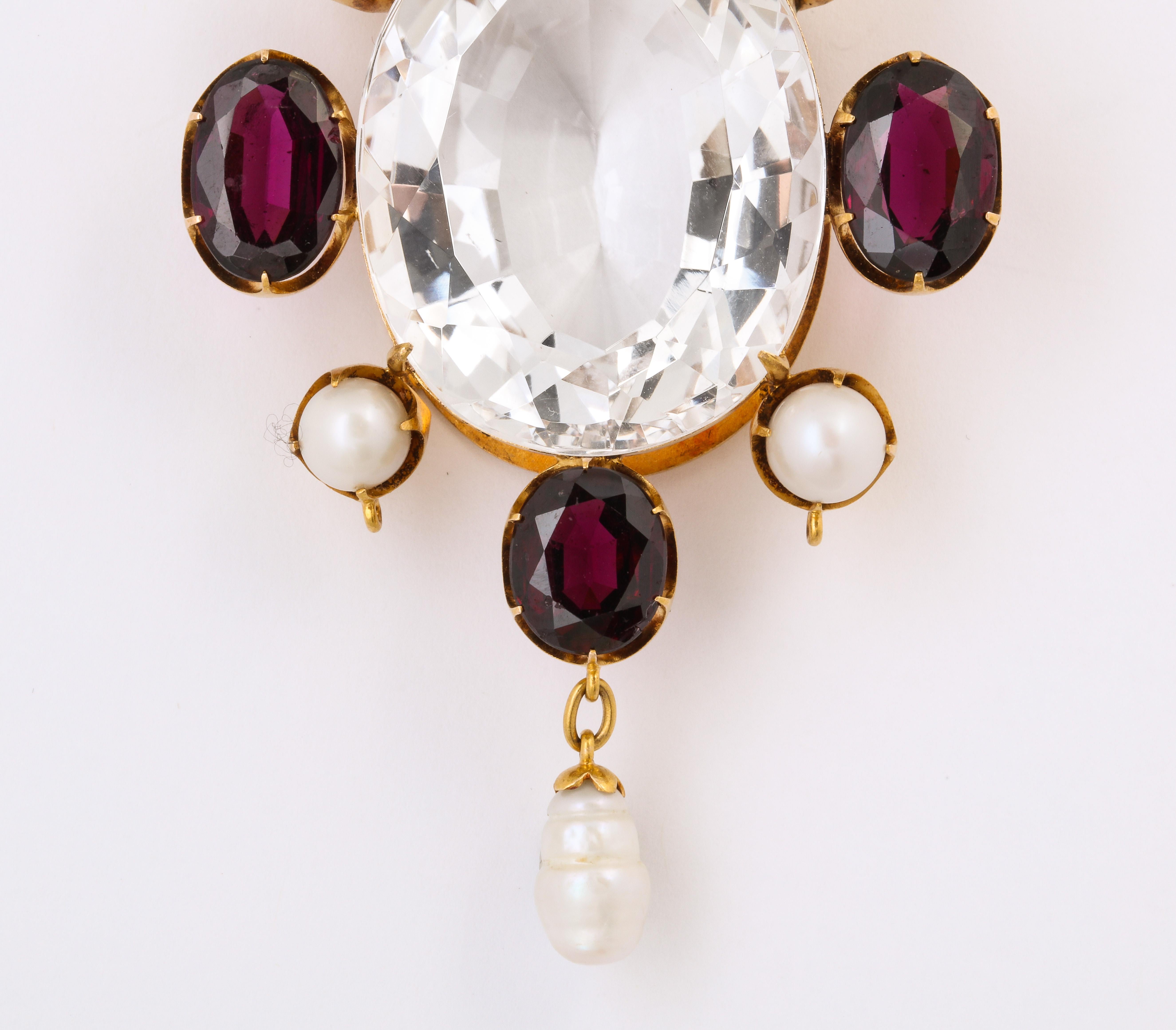 Some like it hot and dramatic which is an accurate description of this large 60ct Victorian Rock Crystal, Garnet and Natural Pearl Pendant. If that is not enough magic, add an original bale, six natural pearls and 11n cts of wine colored garnets. A