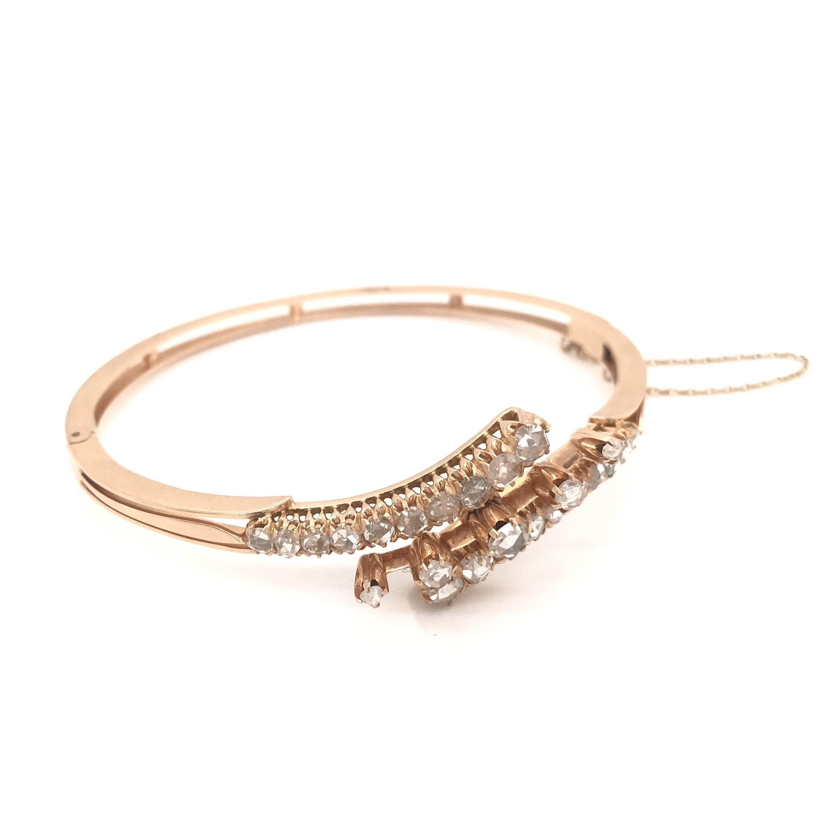 This stunning antique bangle bracelet was crafted sometime during the Victorian design period (1845-1900). The setting is a gorgeous 18K Victorian rose gold. Antique rose gold has a much more subtle and natural coppery hue compared to modern rose