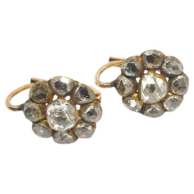 Antique victorian earrings in floral designe centered with large rose cut diamond flanked with smaller rose cut diamonds in back foil old technique excellent facets and spark with estimate weight of 4 carats in 10k gold setting earrings width 1.4cm