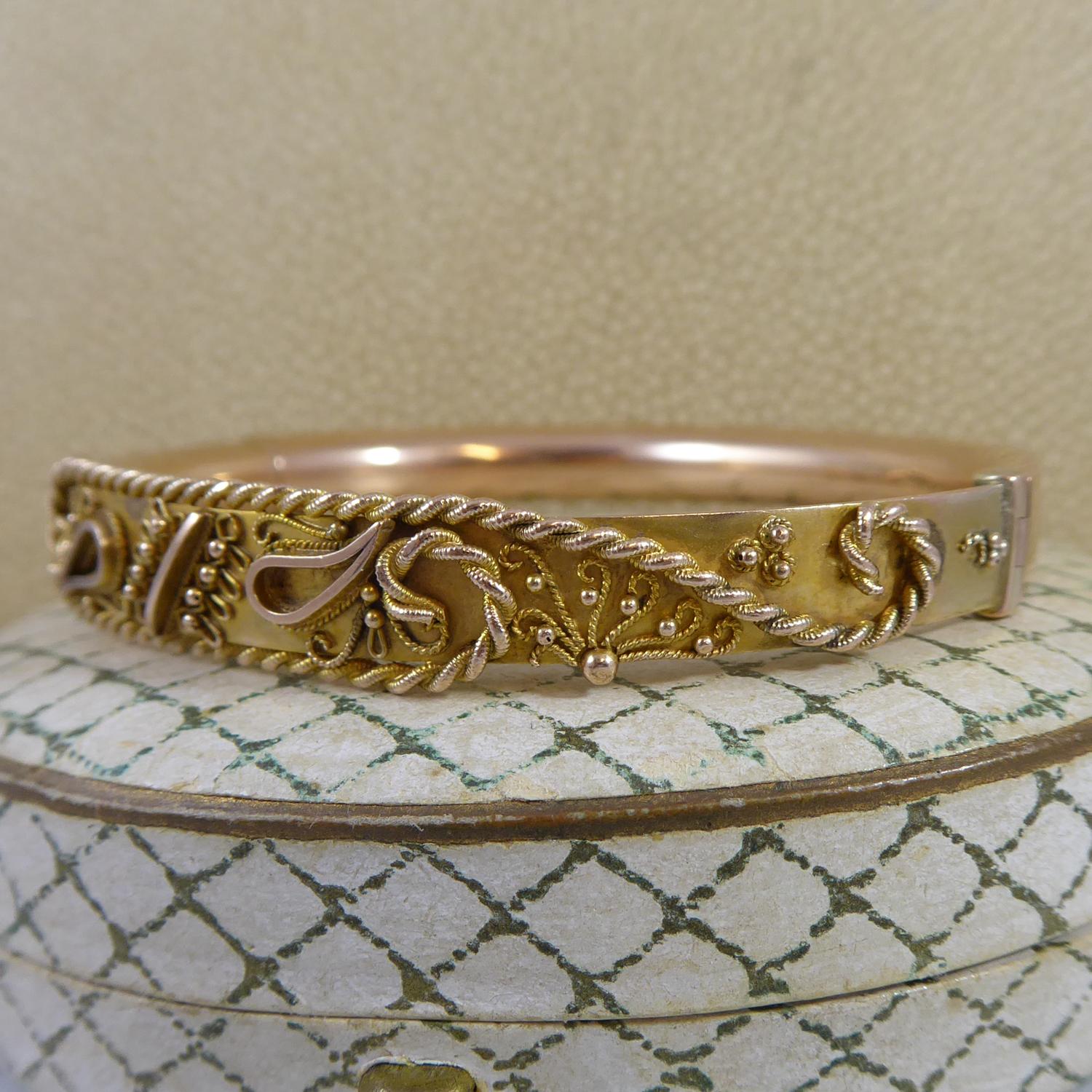 An antique bangle crafted from rose gold at the turn of the 20th century.  The bangle is a D shaped cross section hollow approx. 0.25