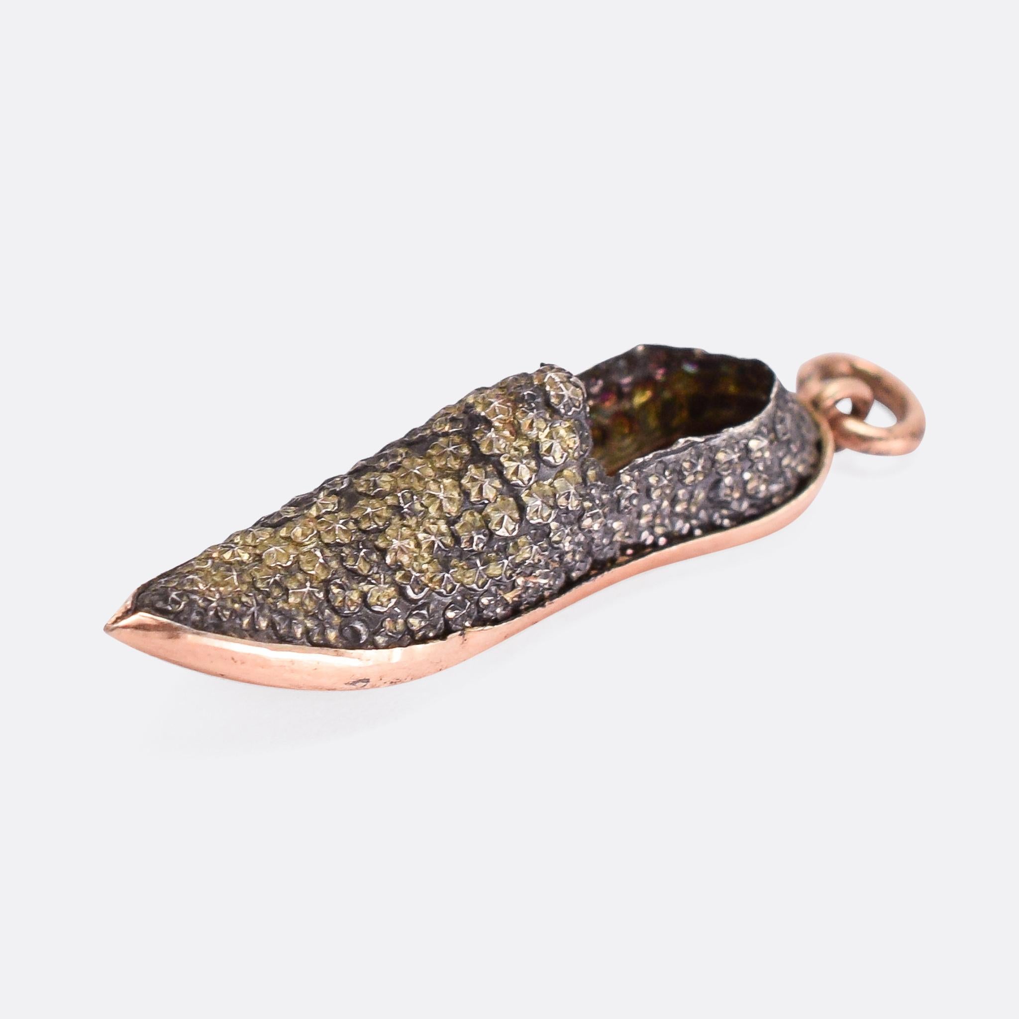 An unusual antique charm pendant modelled as an Arabian style slipper. It’s crafted with a rose gold sole and fittings, and a silver upper – the latter has been worked with little roses of facets, giving a similar effect as cut steel. They date from