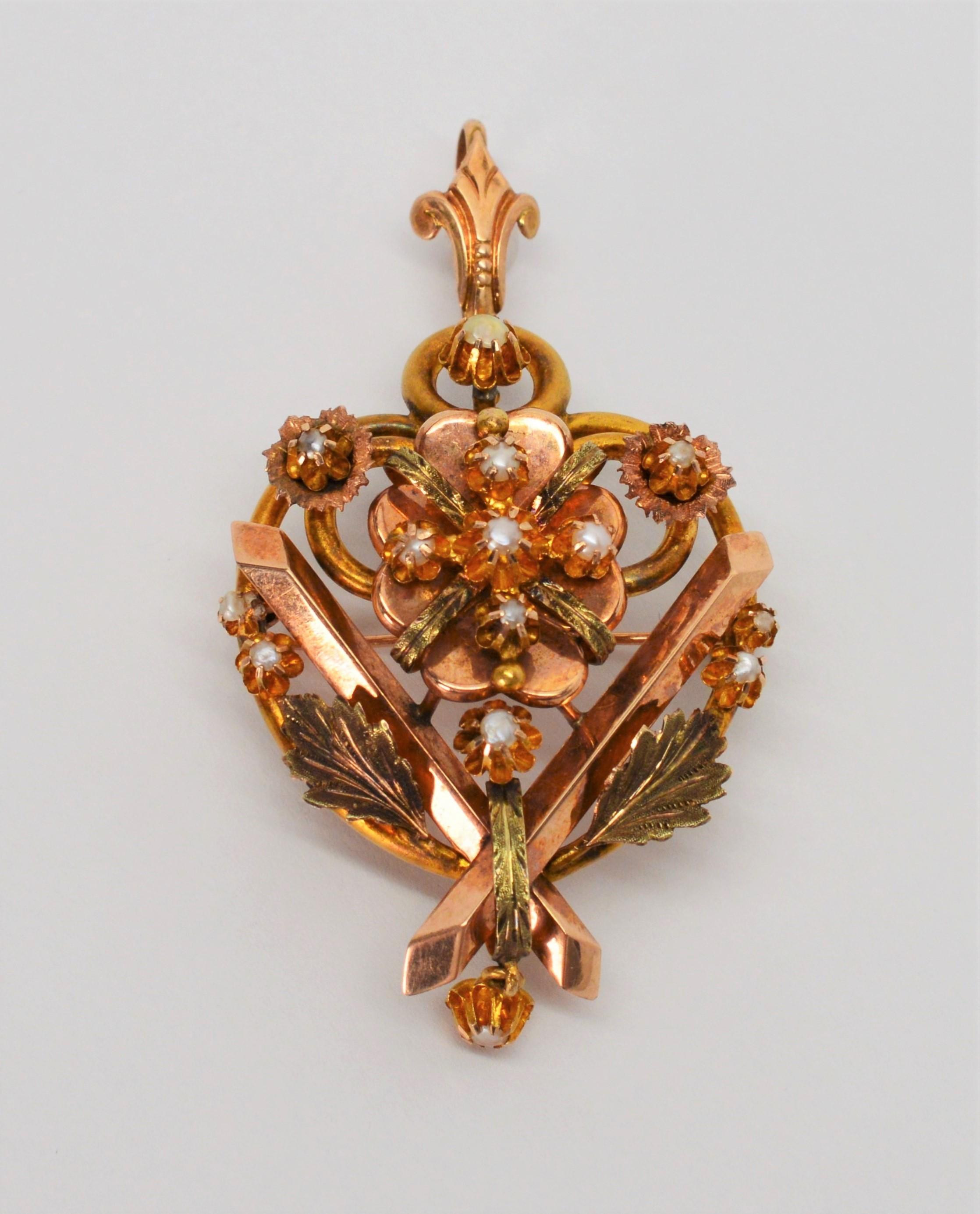 Intricate detail with the use of mixed finishes makes this Victorian brooch an artful stand out piece.  A romantic heart shaped crest is ornately decorated with individually set miniature pearl posies and interpretations of ribbon in yellow and rose