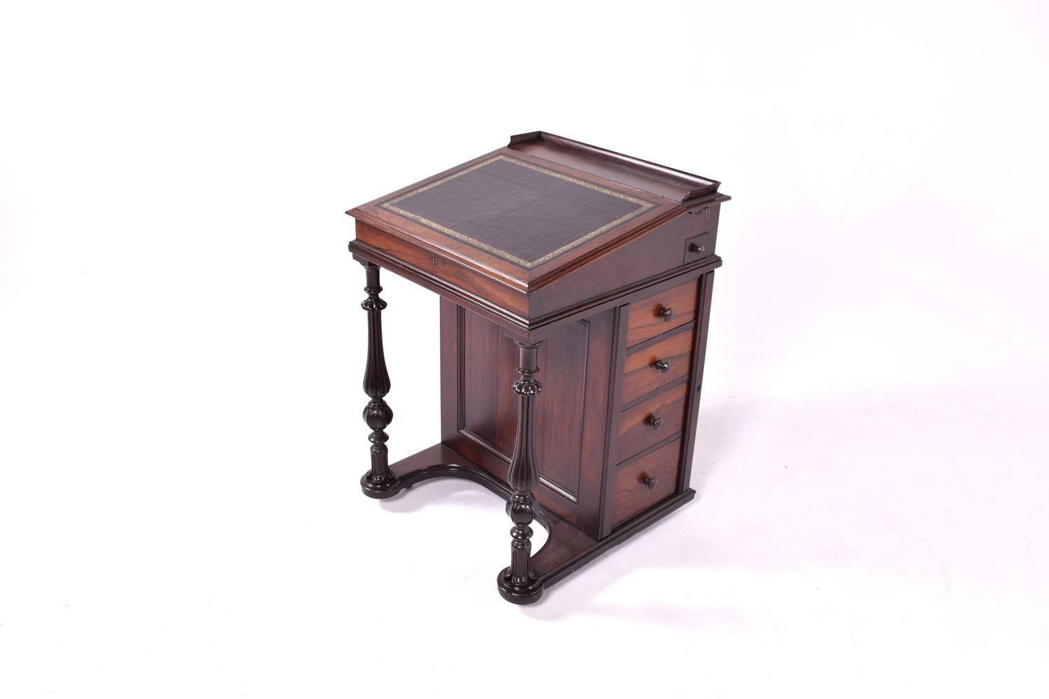 Antique Victorian rosewood davenport, a testament to the exquisite craftsmanship of the era. The piece is characterized by a sliding writing slope that ingeniously moves forward, revealing a practical pop-up document holder and pen tray, perfect for