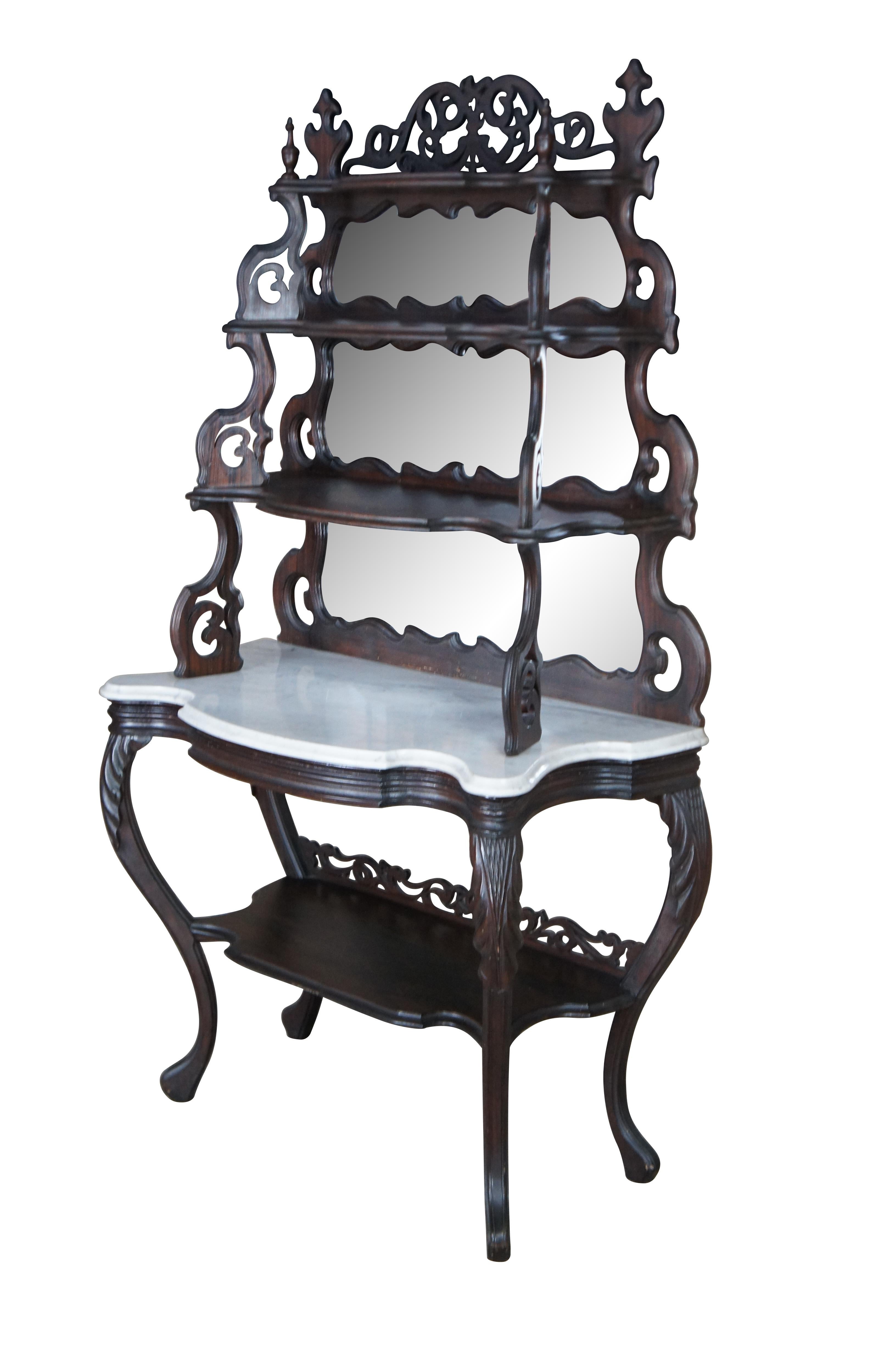Antique Victorian tiered etagere display shelf / library bookshelf / parlor console.  Made of Rosewood featuring serpentine pierced reticulated acanthus design with five tiers and marble top.

Dimensions:
40