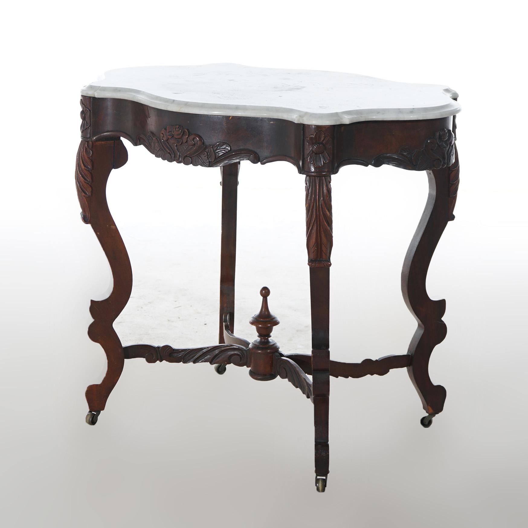 ***Ask About Discounted In-House Shipping***
An antique Victorian parlor table offers shaped and beveled marble turtle top over rosewood base having floral accents and raised on cabriole legs with central urn form finial on stretcher,