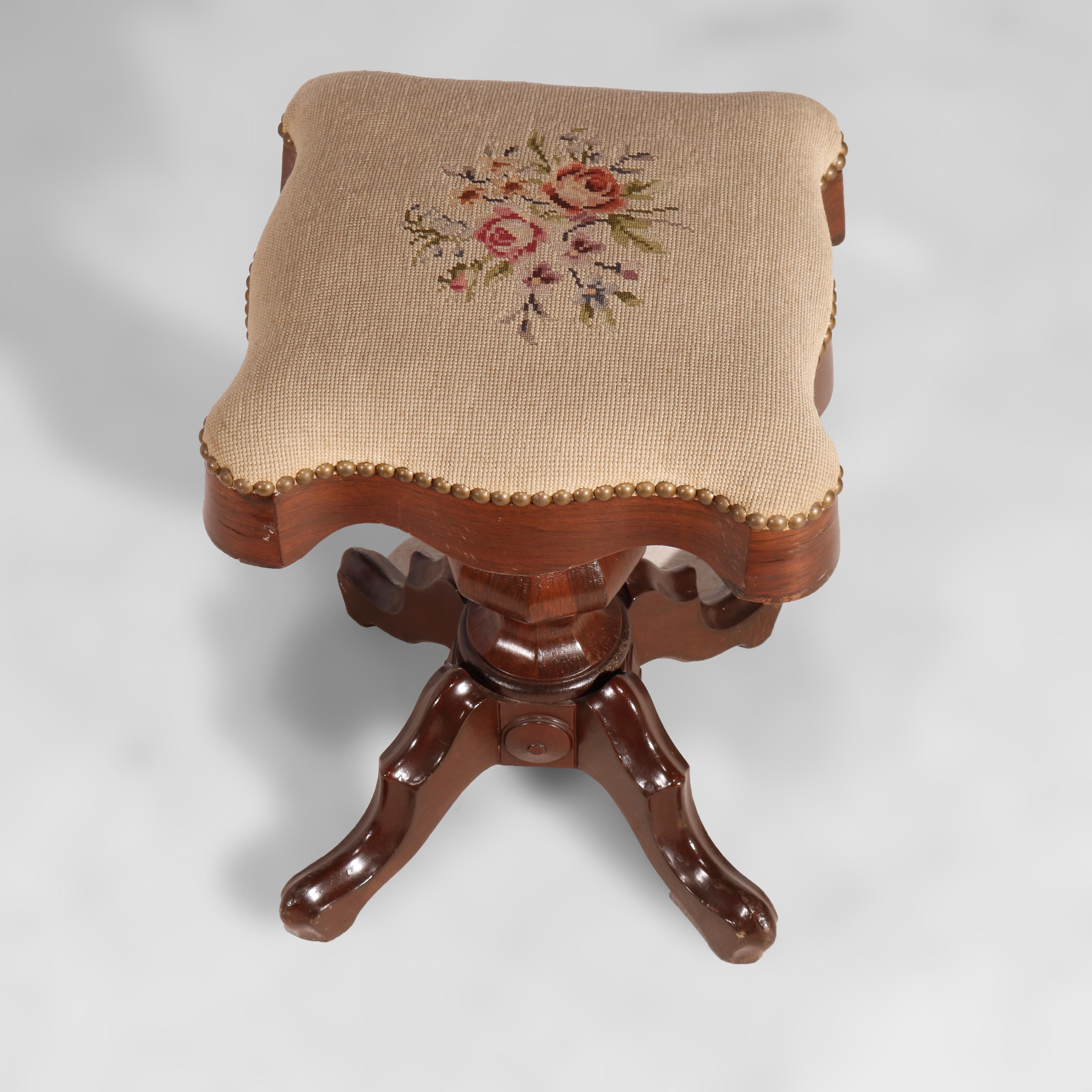An antique Victorian piano stool offers shaped seat with floral needlepoint upholstery over rosewood bae having faceted urn form pedestal with four cabriole legs, circa 1880

Measures - 20.25