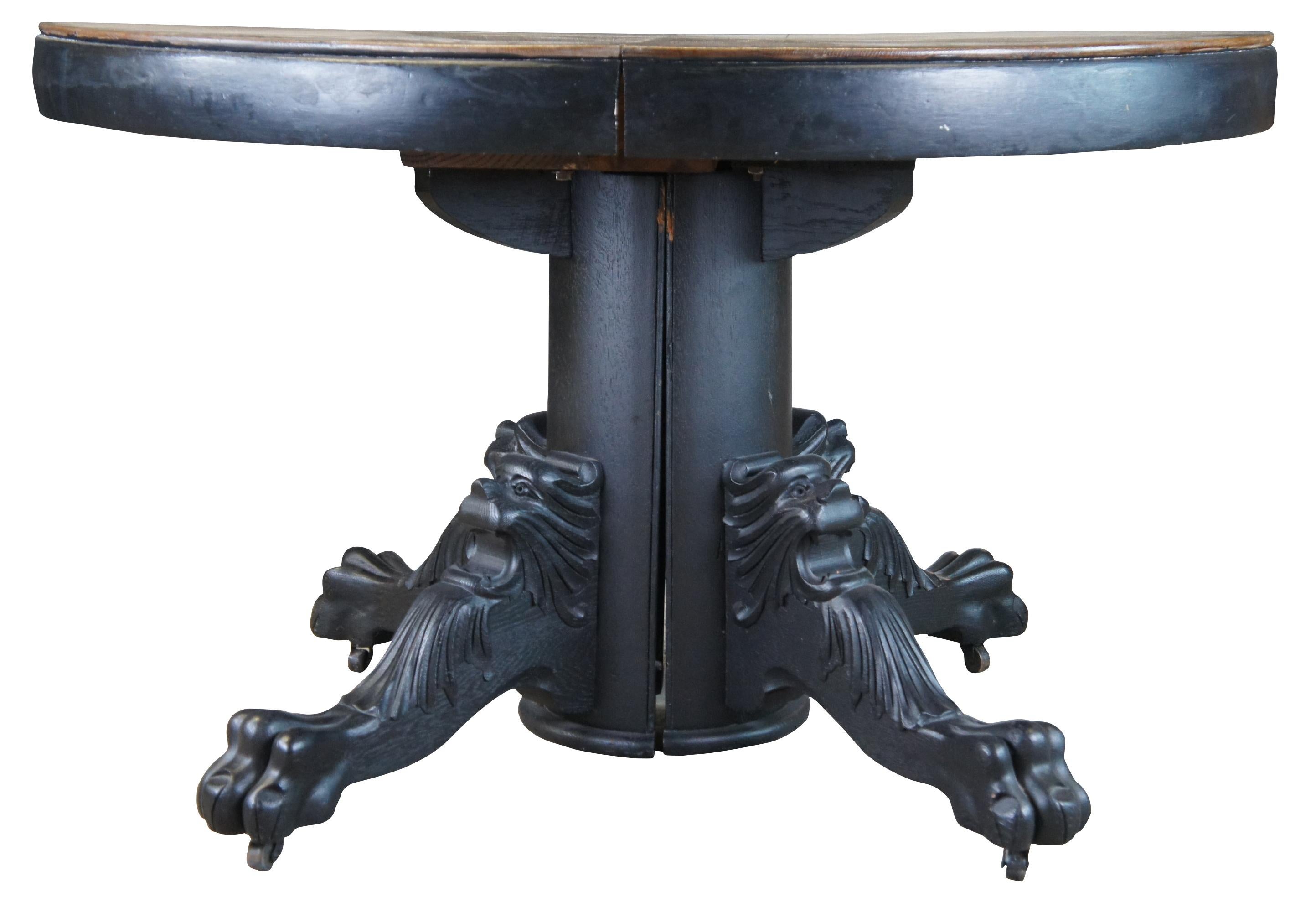 Antique Victorian Gothic Revival extendable dining table. Made of oak featuring round or oval form with carved lion and claw foot base. Includes one 12