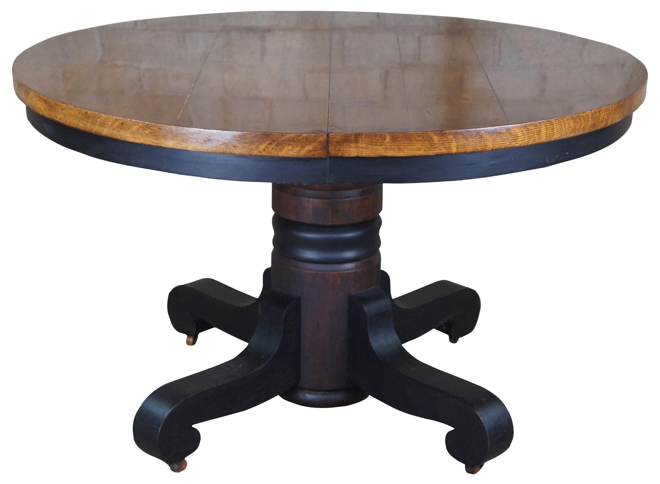Antique Victorian round dining or breakfast table. Made of oak featuring round top and pedestal base with swivel castors.
 