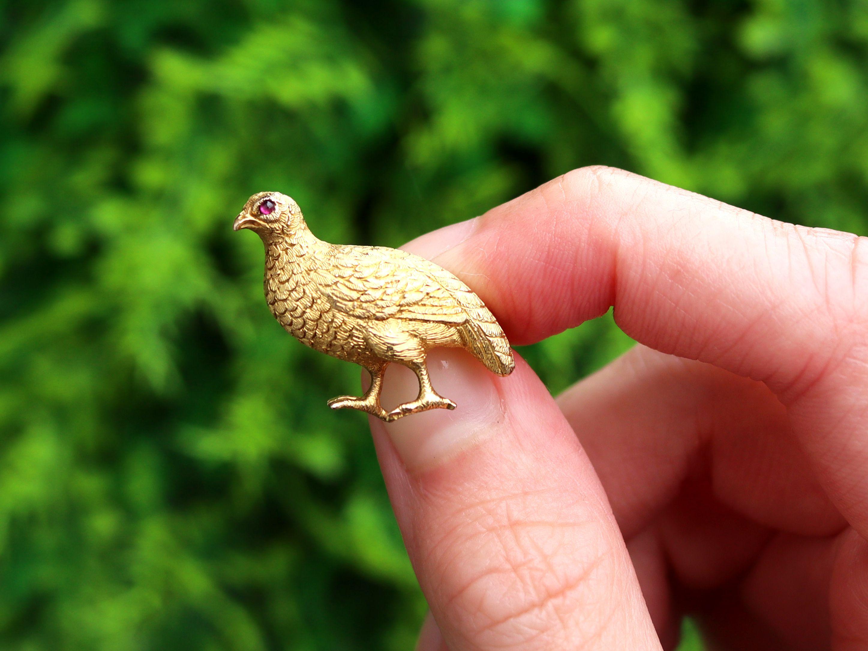 An exceptional, fine and impressive antique 1890s 0.01 carat ruby and 18 karat yellow gold grouse brooch; part of our diverse gemstone jewelry and estate jewelry collections.

This exceptional, fine and impressive antique Victorian brooch has been