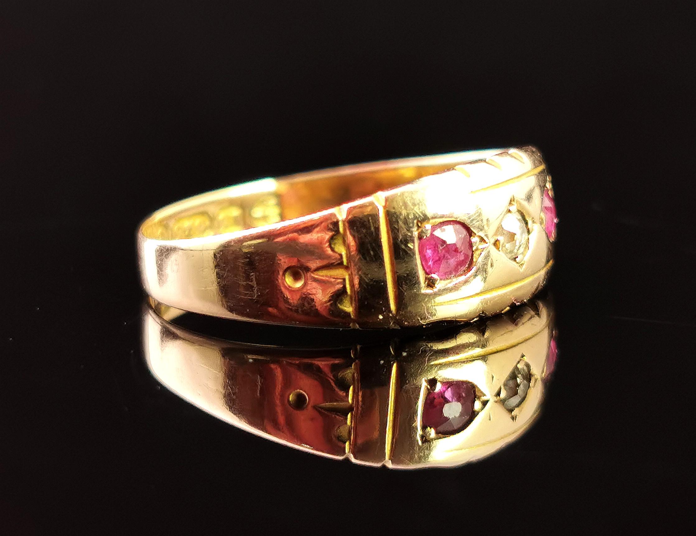 A beautiful antique, late Victorian era Ruby and Diamond ring in 15kt yellow gold.

This beautiful ring is a three stone, Gypsy set ring with a rich golden glow and decorative tapering shoulders.

It is set to the centre with a rose cut diamond chip