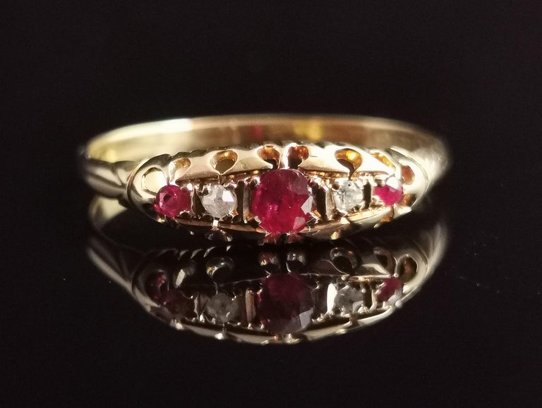A beautiful antique, late Victorian Ruby and Diamond ring in 18kt yellow gold.

This beautiful ring is a boat head style ring with a gemstone set face.

It is set to the centre with an oval cut Ruby with diamond chips either side and a further two