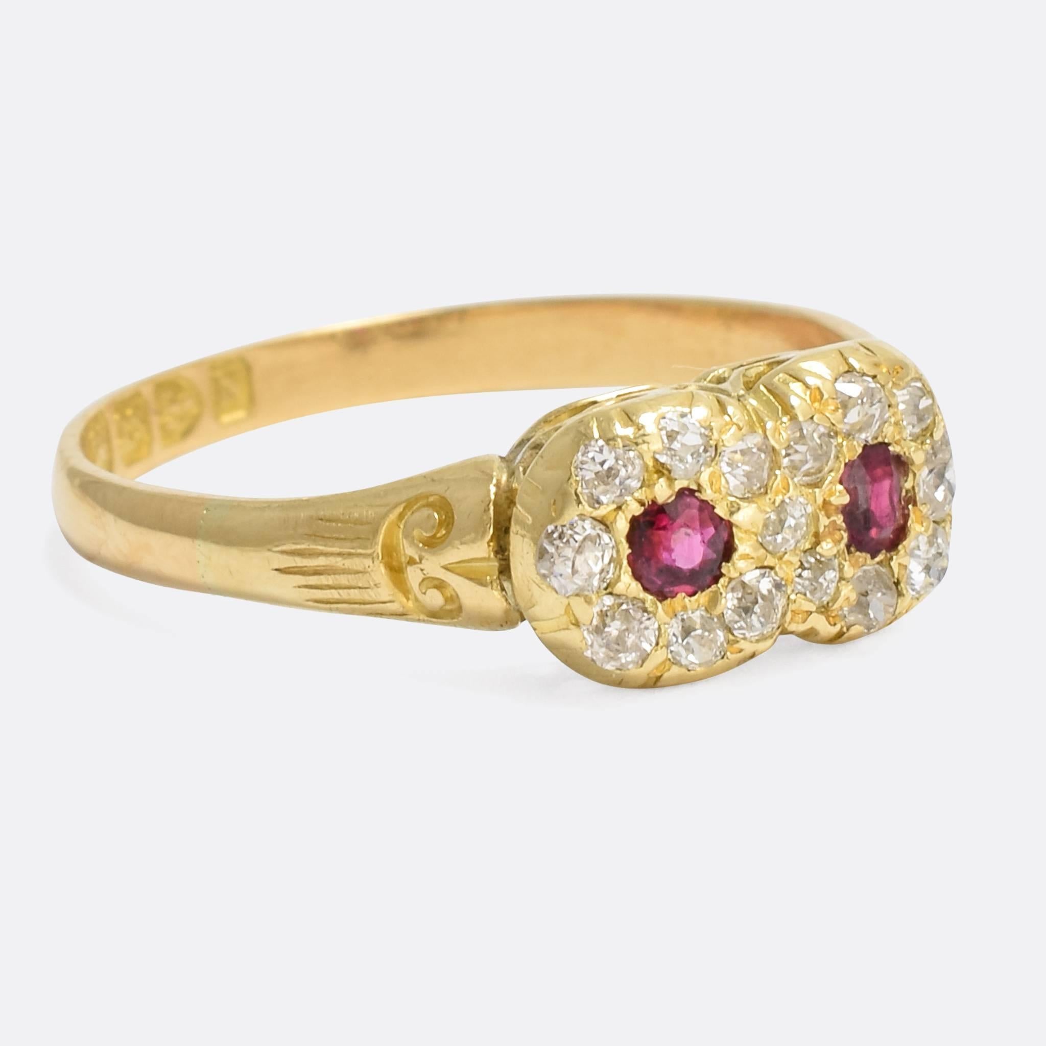 An adorable antique double cluster ring, set with two natural rubies and old cut diamonds. The two clusters are overlapped, a sweet toi et moi sentiment, and the shoulders feature deeply chased scrolled detailing. Clear English hallmarks indicate
