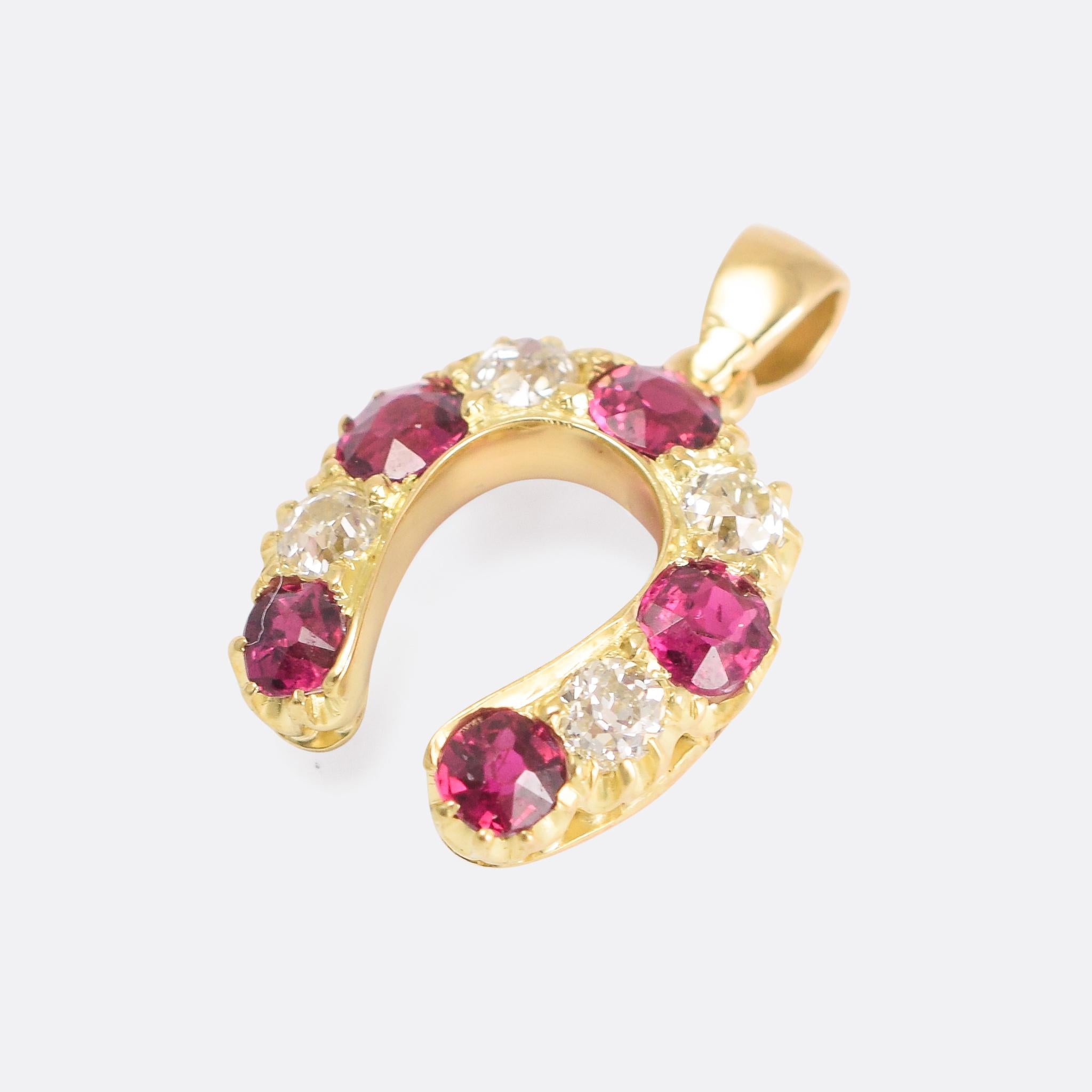 Beautiful antique horseshoe pendant set with bright old cut diamonds and vivid rubies. It has been expertly hand crafted - circa 1880 - and modelled in 15 karat gold. Home to a particularly lovely set of stones; it's bound to bring you good