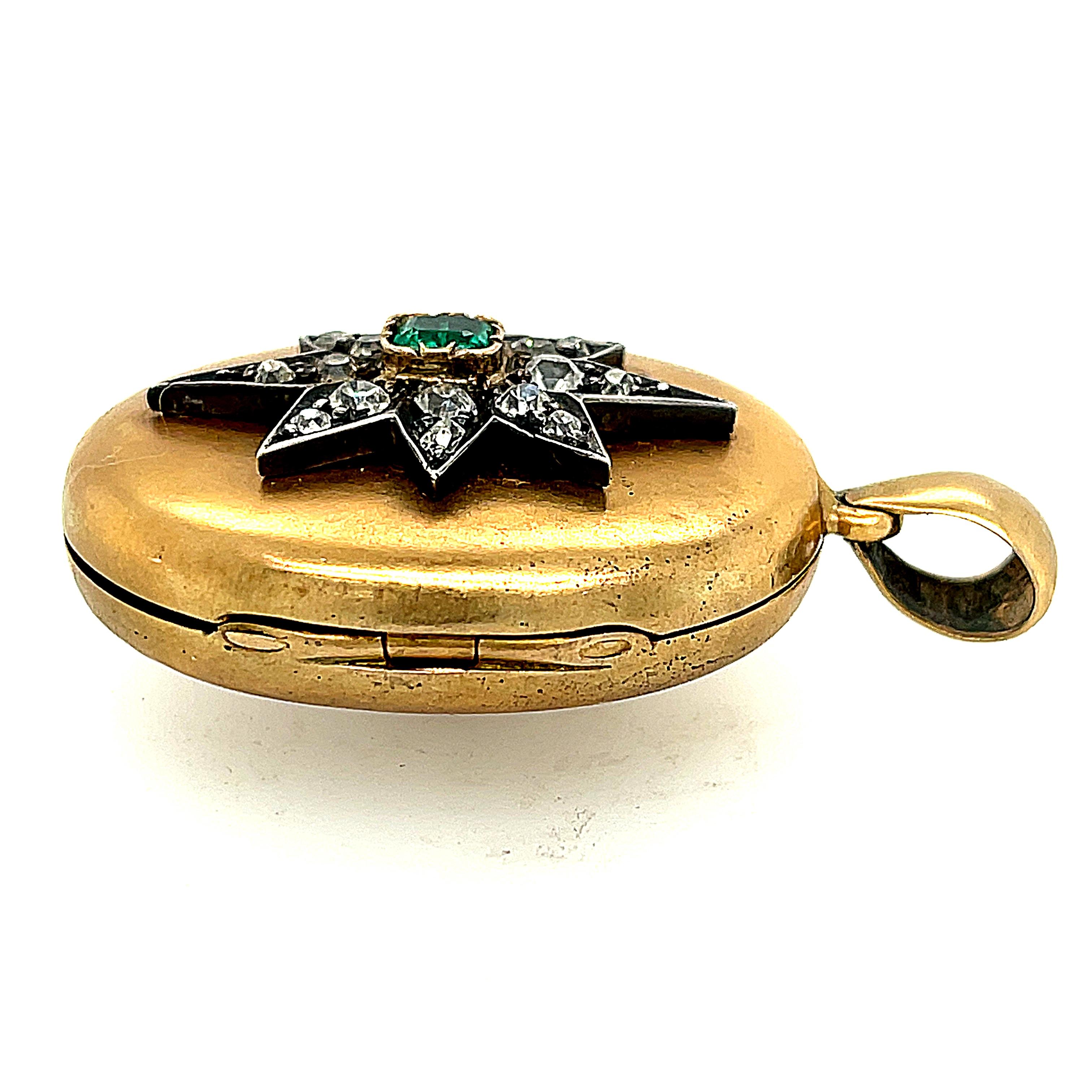 Rare double sided antique 14k yellow gold locket, circa 1880. One side of the locket is set with a silver and diamond star centering on a ruby and the other side is set with an identical star with an emerald. Two locket looks in one! The stars are