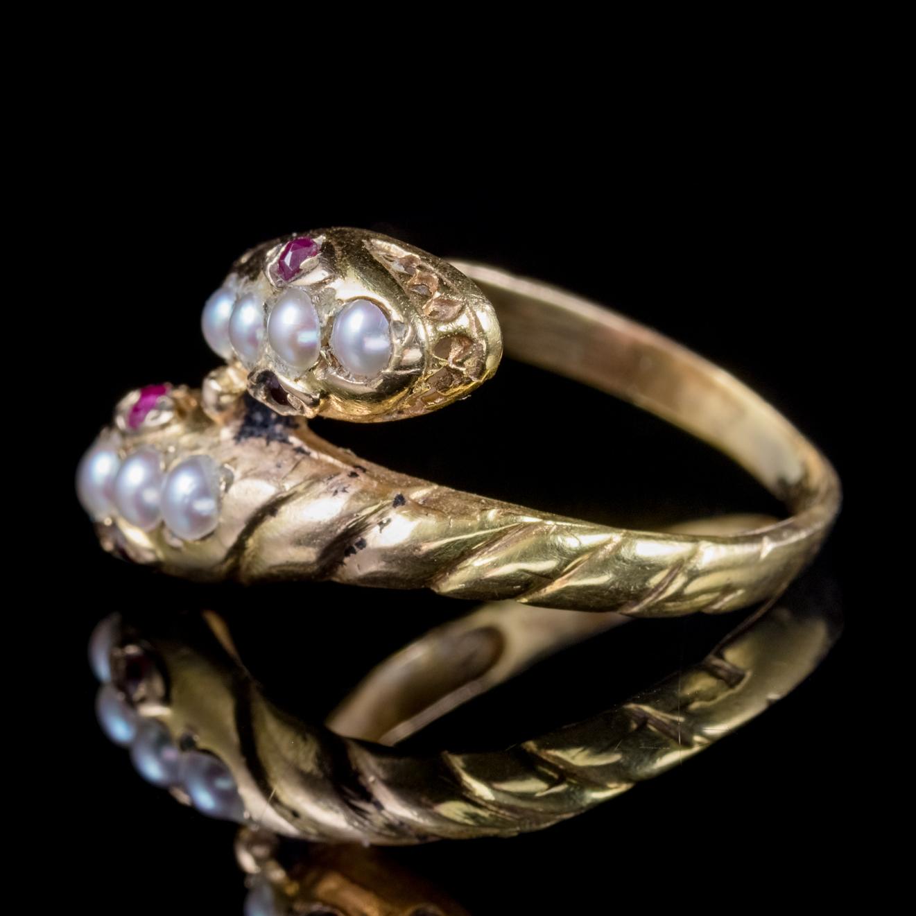 A lovely antique Victorian serpent ring C. 1880, featuring two coiled snakes crowned with natural Pearls and red Ruby eyes. 

Serpent jewellery became popular during the early years of Queen Victoria’s reign coinciding with the full flowering of the