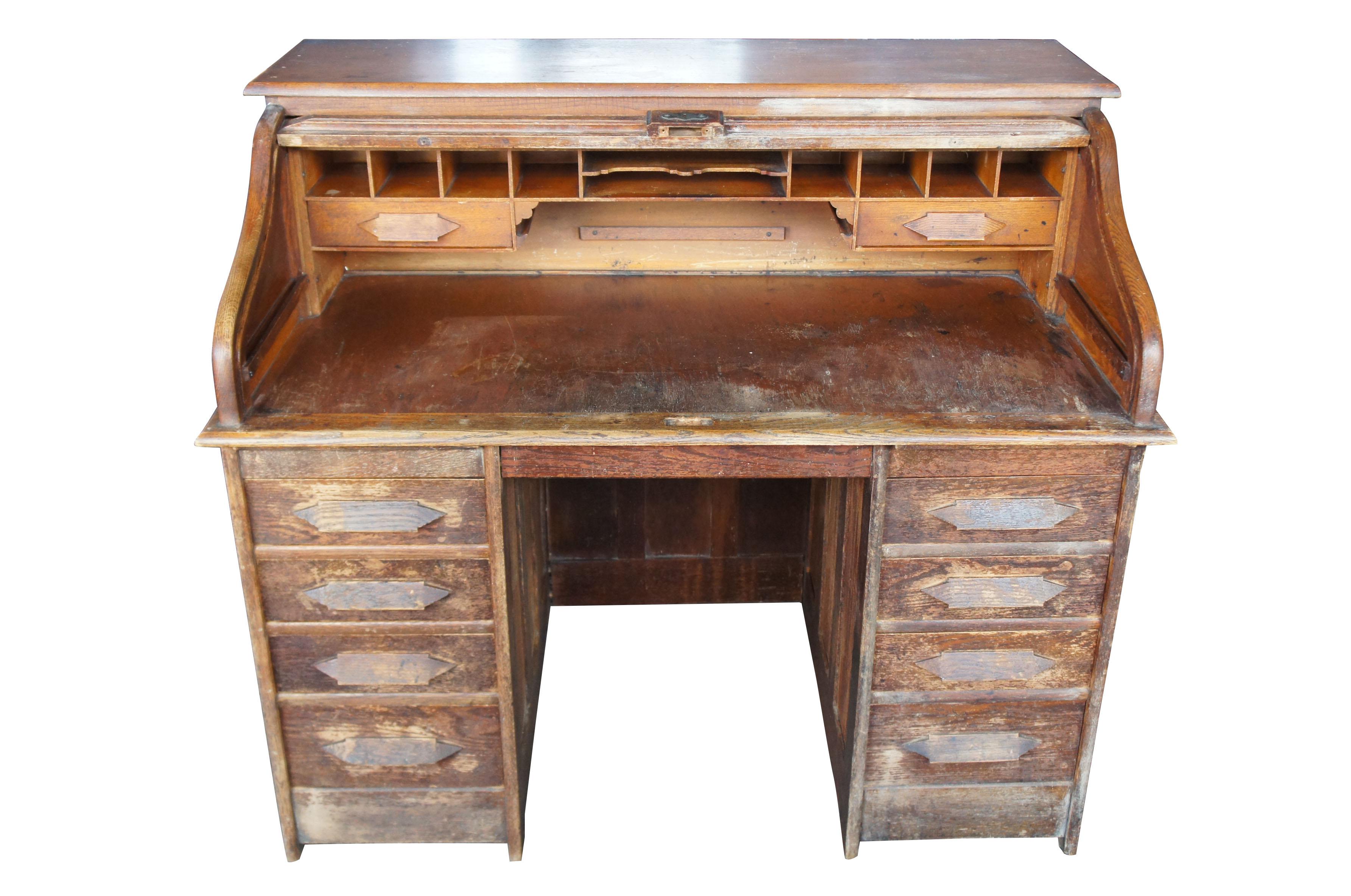 Antique Victorian S-curve solid oak roll top desk tambour door side drawers

Late 19th century Victorian desk. A beautifully designed S-curve roll top with tambour door. Opens to several pigeon holes and drawers. Lower portion has four drawers