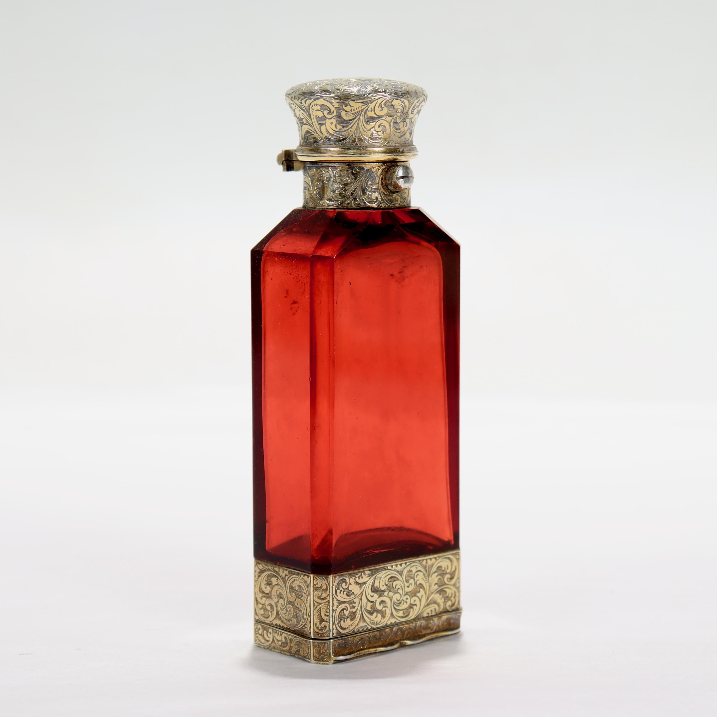 A fine antique Victorian glass & sterling silver perfume bottle with an integral vinaigrette.

By Sampson Mordan

With a faceted ruby glass bottle mounted in etched gilt silver mounts with an integral vinaigrette to the base. 

Simply a great
