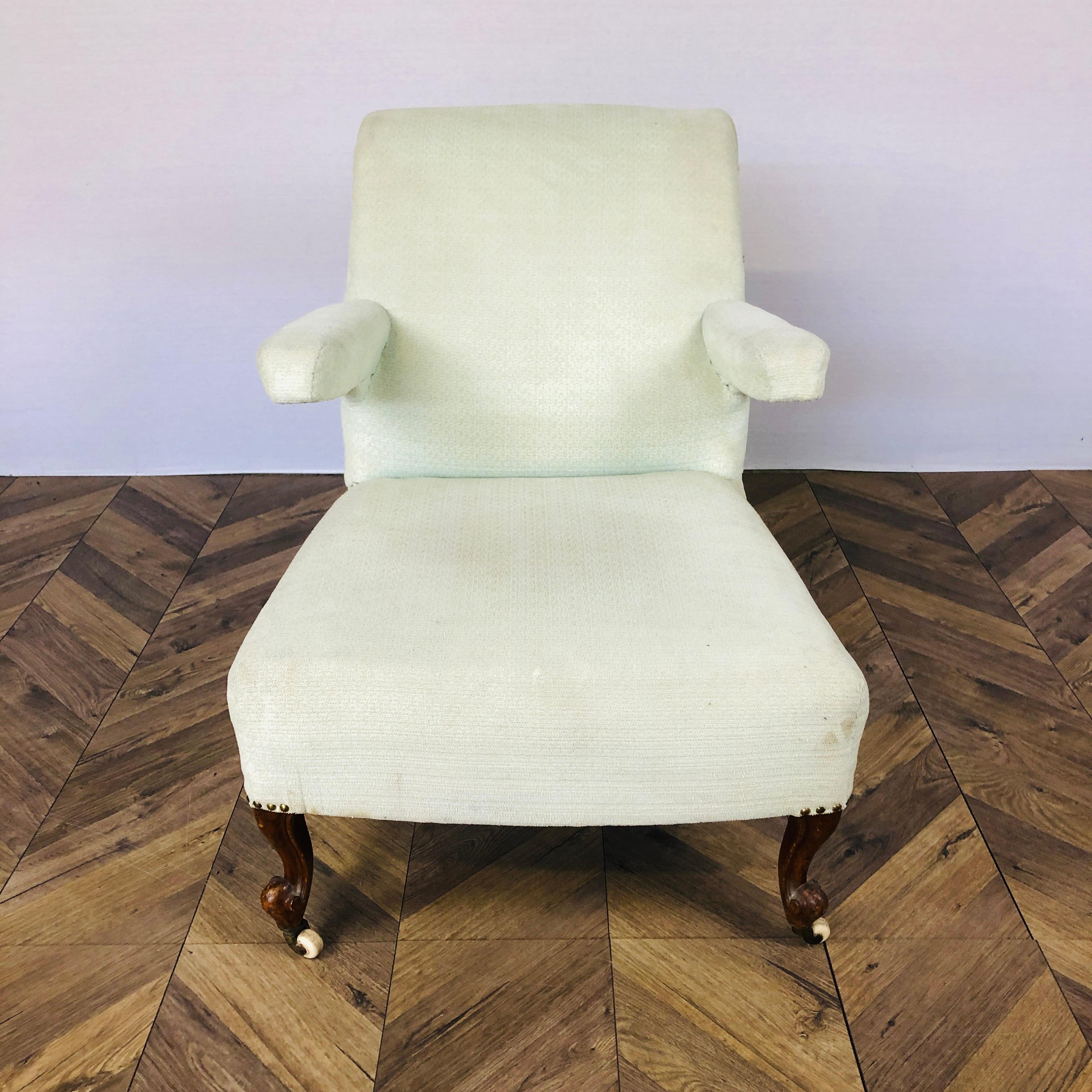 A Well Proportioned, Unusual Victorian Salon or Medical Armchair. Circa 1850s. 

The chair features a slanted back with scrolled / rolled top and floating armrests. The chair sits on original castors and 4 ornate legs.

The pale green / beige