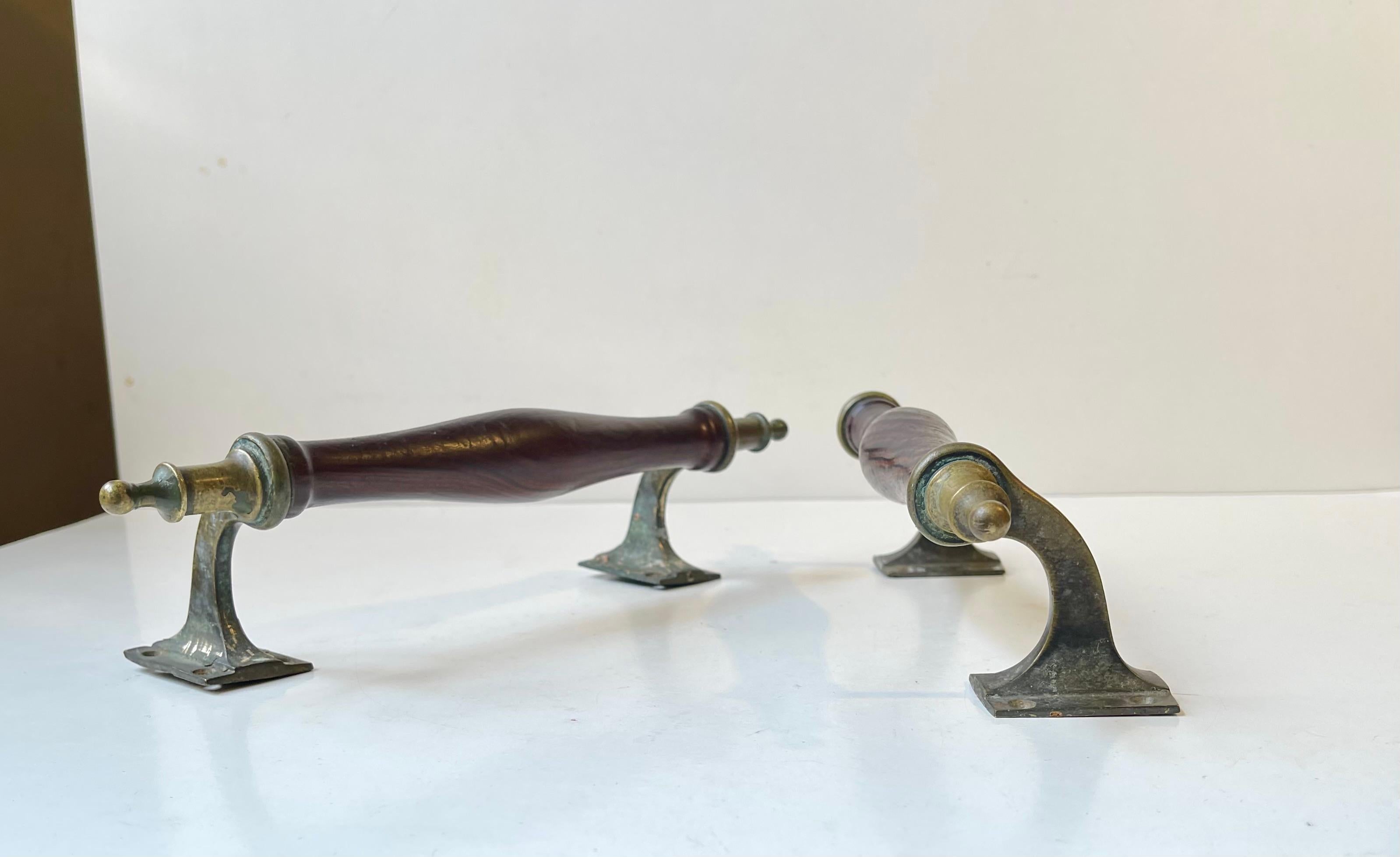 A pair of elegant ornamental door handles for a saloon door, sliding door or an antique gate. Due to their width and brass resets they can also be used in your bathroom for towels, as hangers etc. These were made in Scandinavia, probably Denmark,