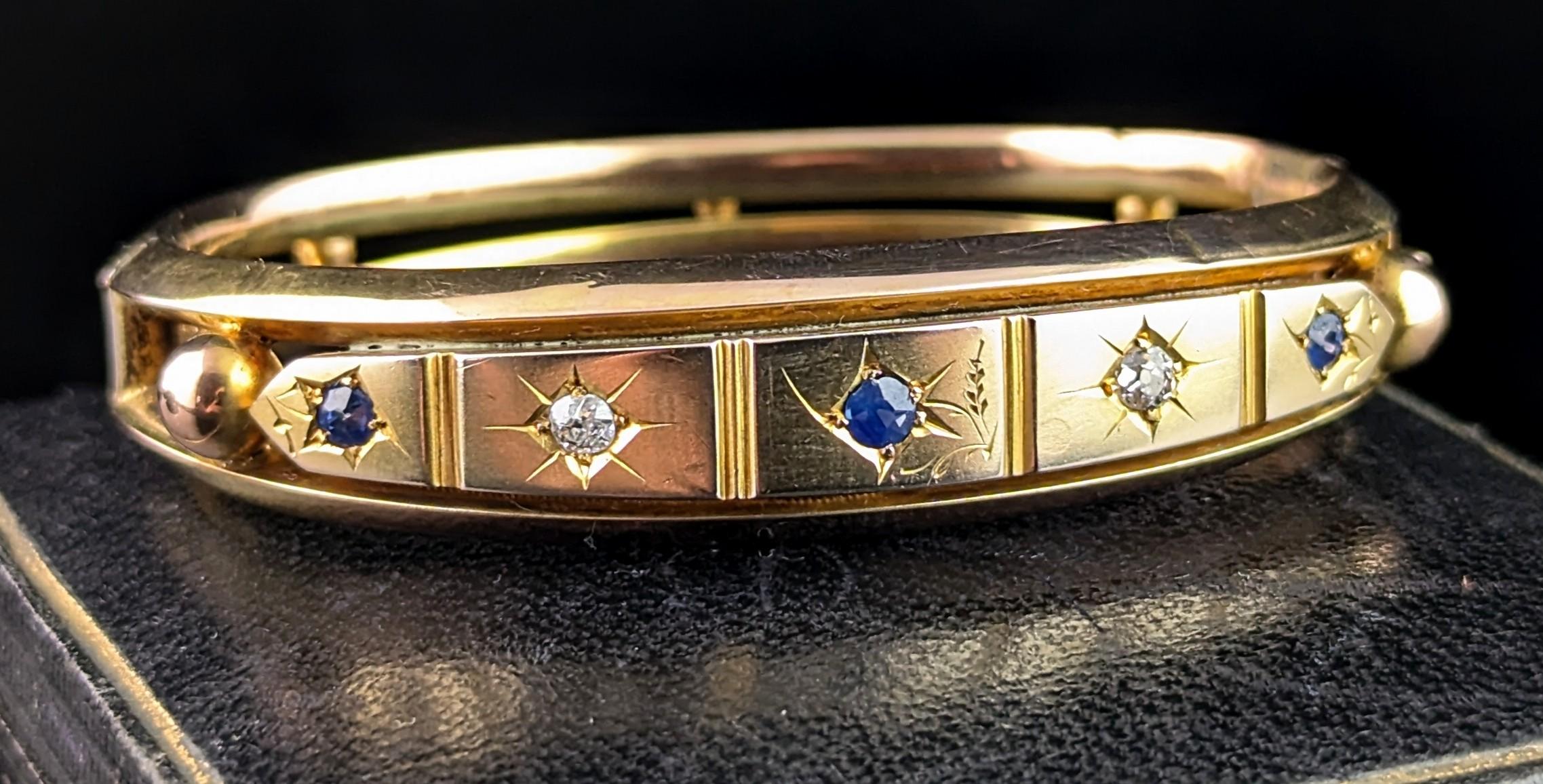 A gorgeous antique Victorian era Sapphire and Diamond bangle in 9ct yellow gold.

It is on the chunky side for this style of bangle which is a nice feature, it has a star set face with alternating blue sapphire and old cut diamonds.

The central