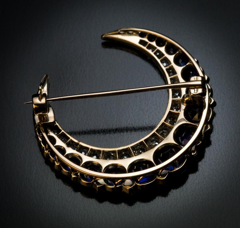 Circa 1890

This antique 14K gold and silver crescent shaped brooch is set with excellent royal blue sapphires accented by sparkling old mine cut diamonds.

The biggest sapphire measures 5.75 x 4 mm and is approximately 1 carat.

Estimated total