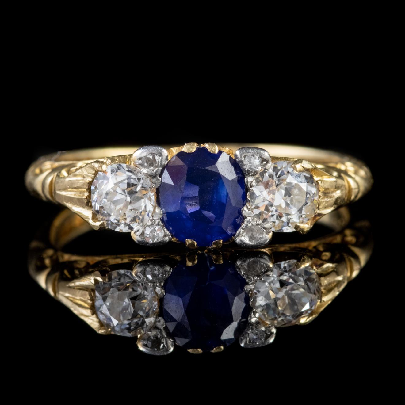 A stunning antique Victorian trilogy ring crowned with a central 0.80ct blue Sapphire flanked by two gorgeous 0.25ct Diamonds which are superb VS1 clarity – H colour stones accompanied by four smaller Diamonds that make a total of approx. 0.60ct.