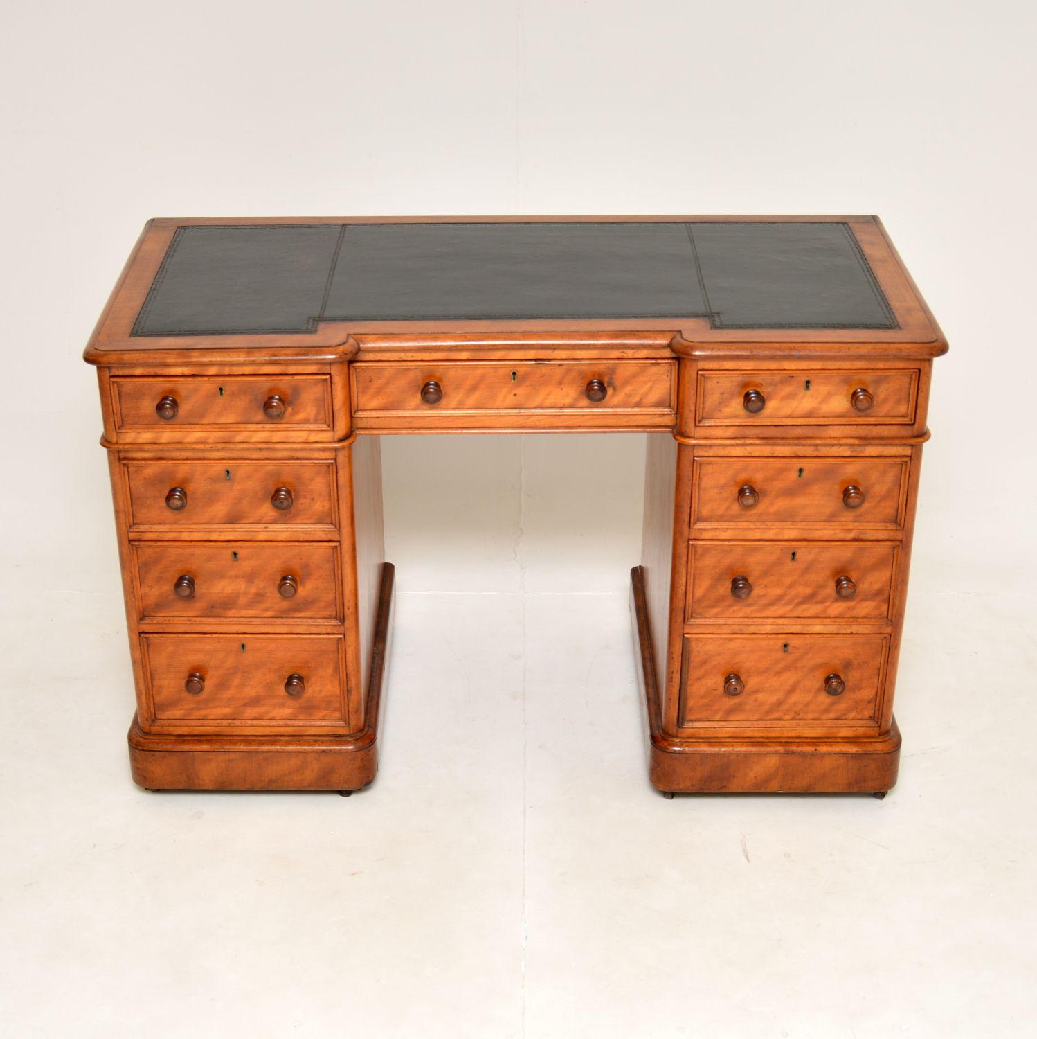 A superb antique Victorian pedestal desk, beautifully made from satin wood. This was made in England, it dates from around the 1860-1880 period.

It is of very fine quality, with a lovely inverted breakfront design. It sits on plinth bases with