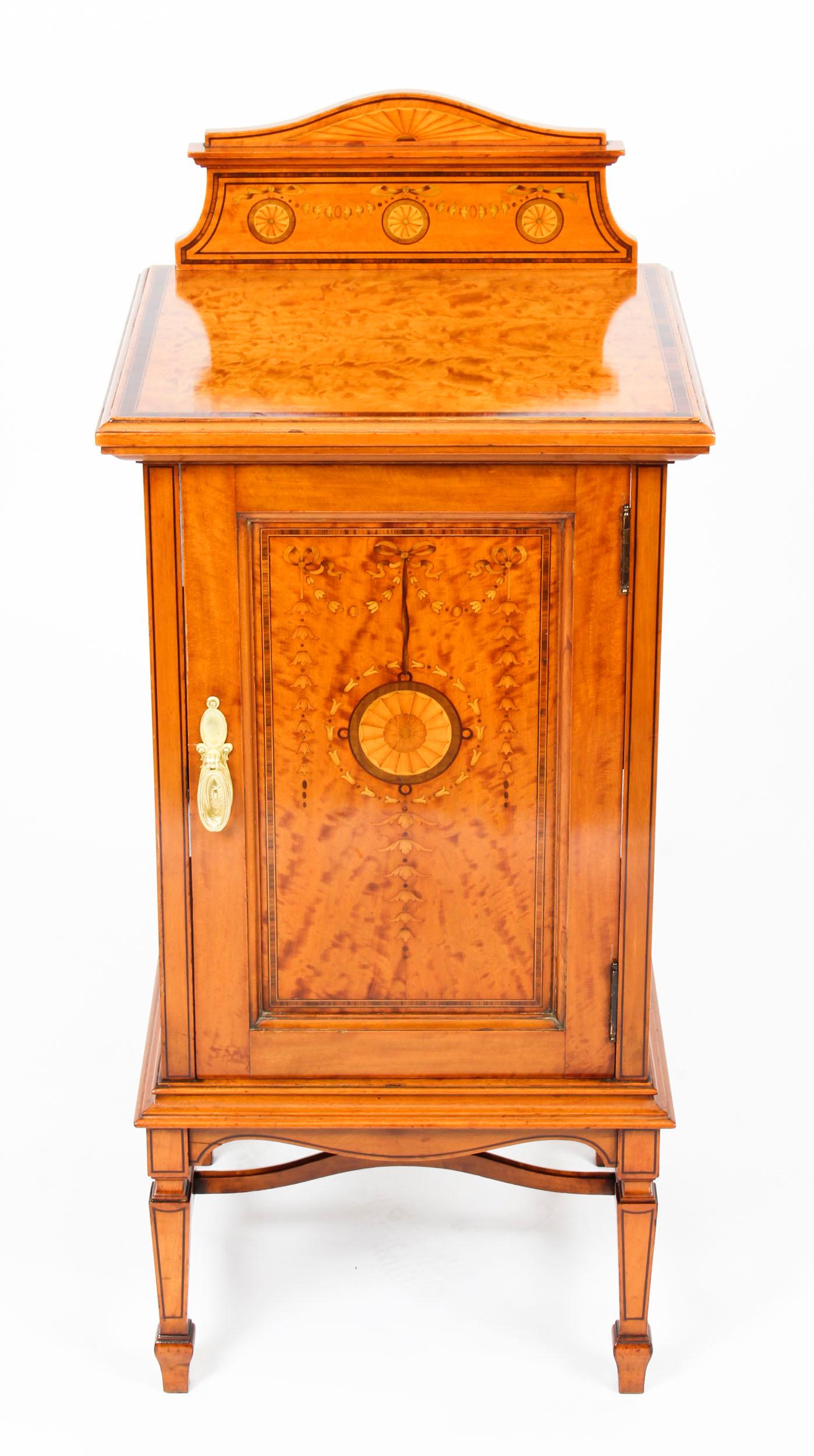 This is a splendid antique Victorian satinwood bedside cabinet, circa 1880 in date.

This superb antique cabinet features attractive marquetry decoration.

The bedside cabinet has a cupboard with a central shelf and is raised on elegant square