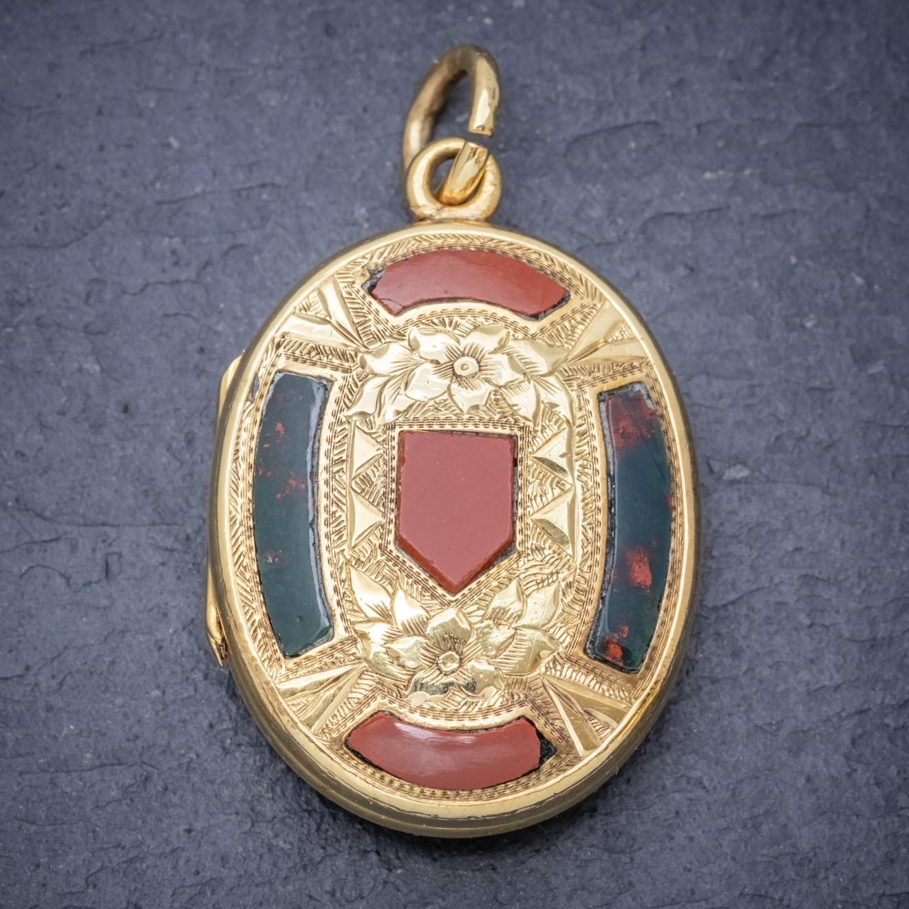 A wonderful antique Scottish Mourning locket from the Victorian era featuring beautiful engraved artistry on both sides with floral motifs displayed around lovely Jasper and Carnelian stones. 

The locket opens up to reveal beautiful plaited hair