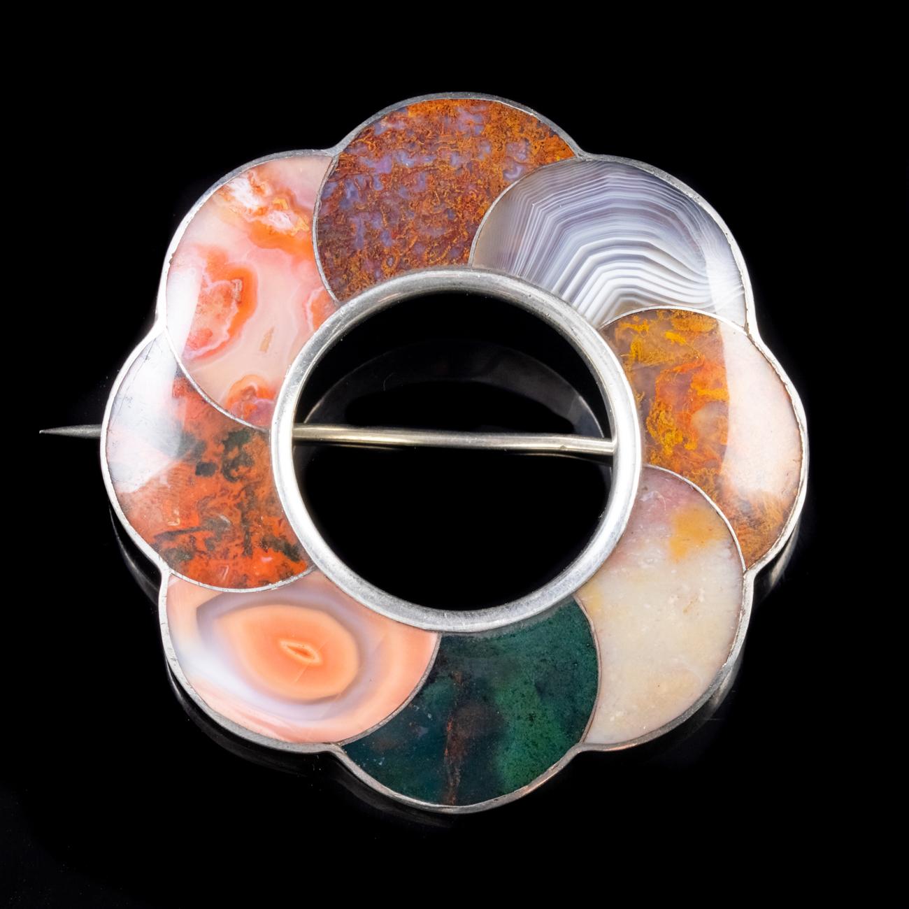 This truly stunning Antique Victorian Scottish brooch has been commissioned in Sterling Silver to form the shape of a flower and plaid set with eight magnificent examples of gorgeous Scottish agate.

Each Agate is unique and boasts various earthy