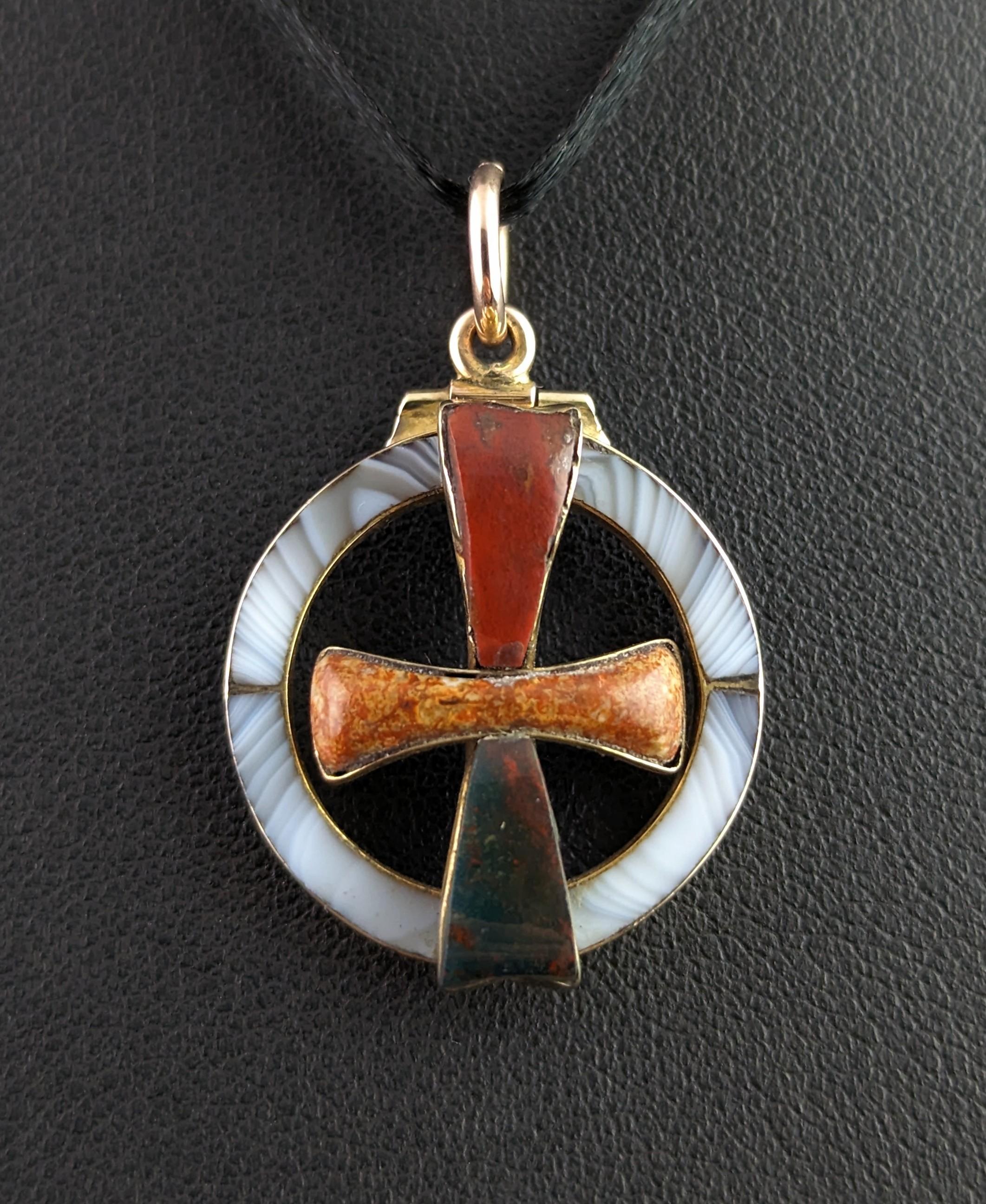 We love this unusual antique, early Victorian era Scottish agate conversion pendany.

Circular in shape it has a cut out design with a cross to the centre, the cross is set with varying agates including red jasper, jasper and bloodstone.

The warm