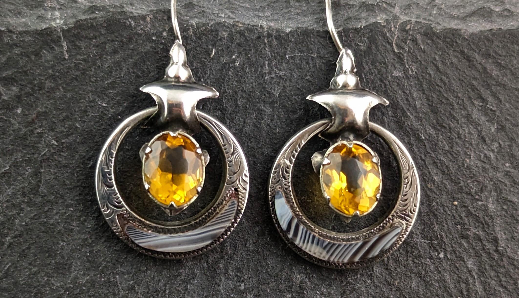 A beautiful pair of Antique, Victorian era sterling silver and Scottish agate drop earrings.

Crafted in the aesthetic era these earrings are made from sterling silver, the silver is pressed out or hollow which gives a heavy appearance without the