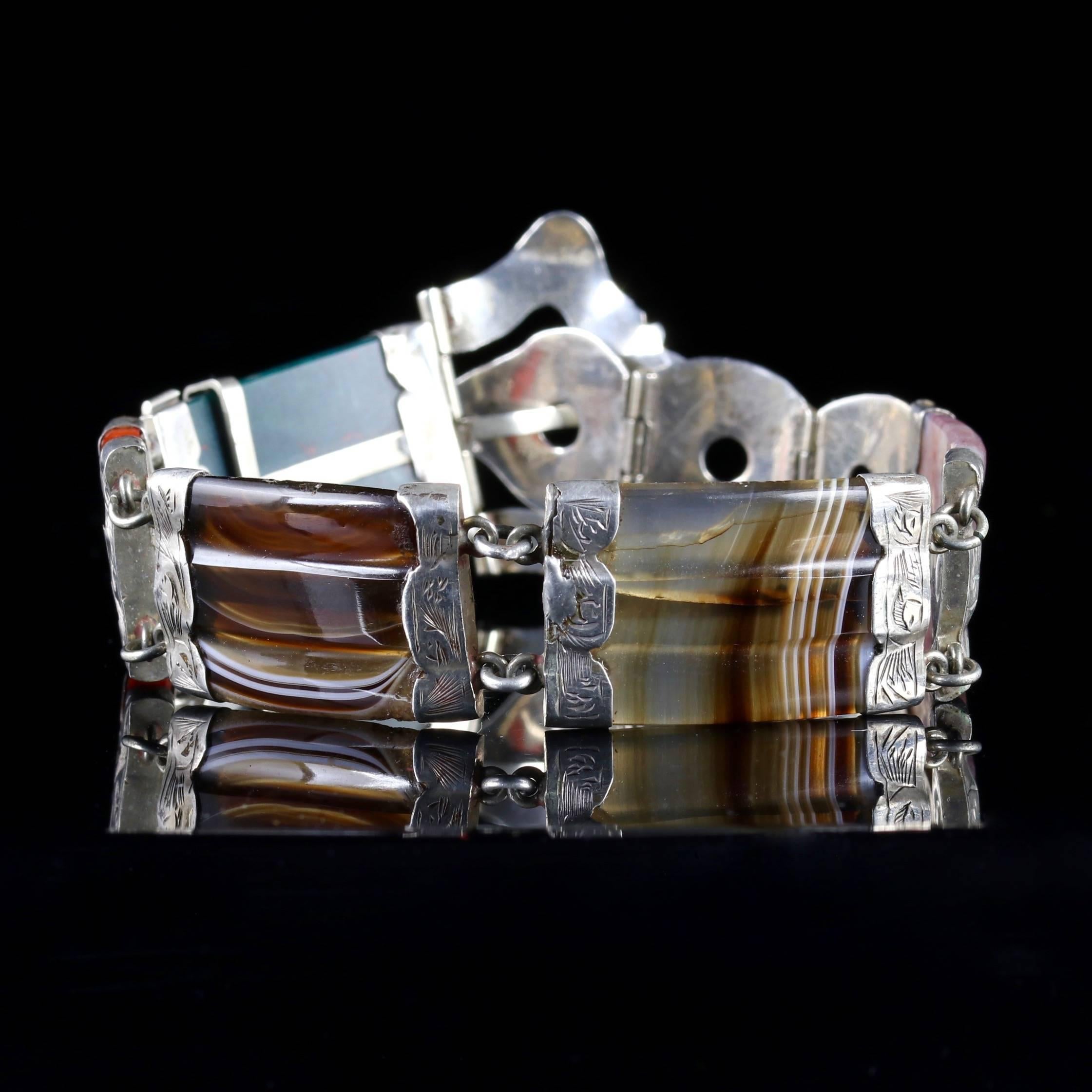 This beautiful Victorian Scottish Silver buckle bracelet is Circa 1860.

The bracelet is fitted with Agate Links, which are set with beautifully engraved floral Silver panels and a fabulous adjustable buckle clasp. 

The Agates show the natural