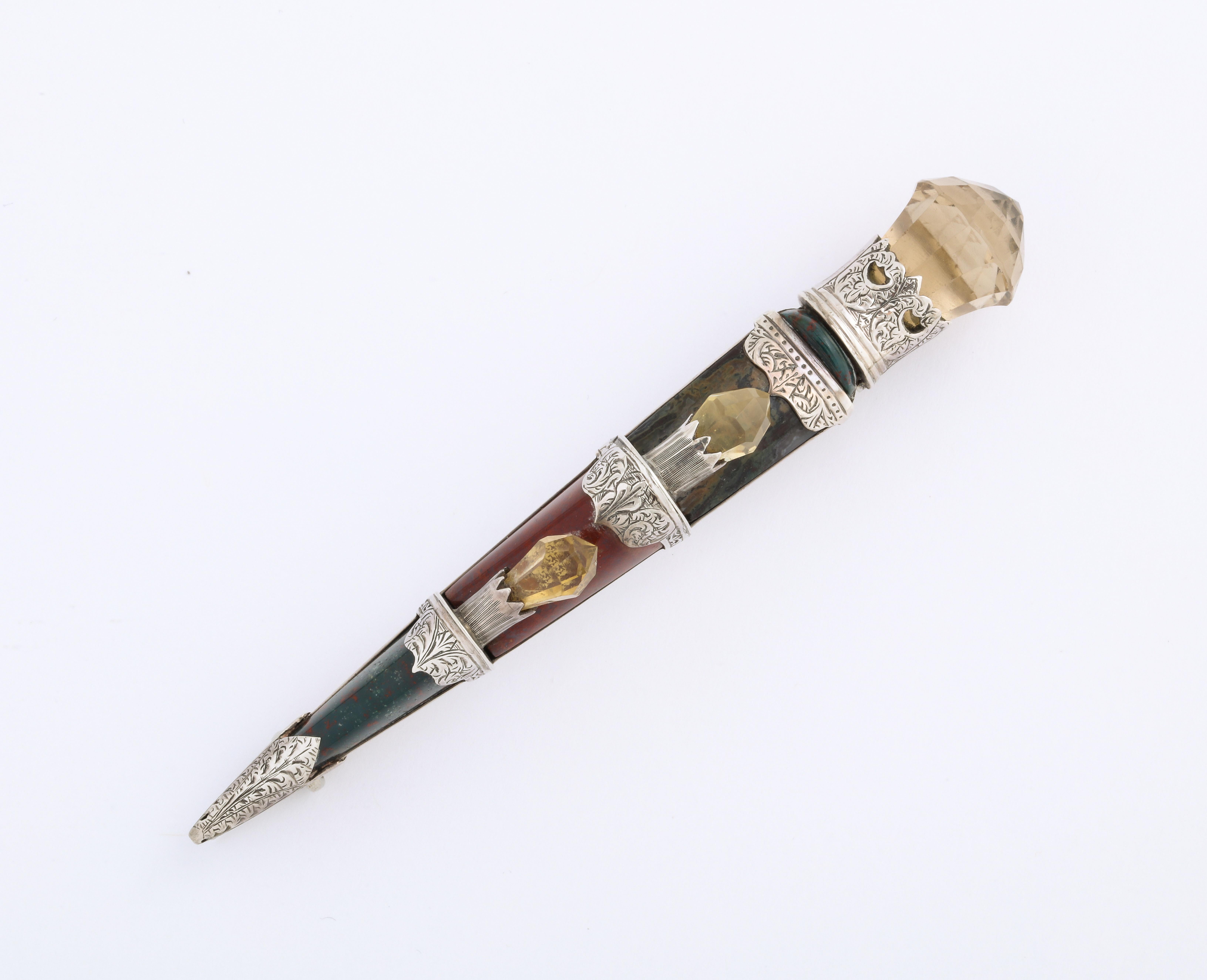 Lovers of Scottish Jewelry unite and cheer this sterling silver large dirk set with moss agate bloodstone and carnelian, topped by a beautiful prism shaped citrine, known in Scotland as a Cairngorm. The dirk is broad and long. Each agate section is