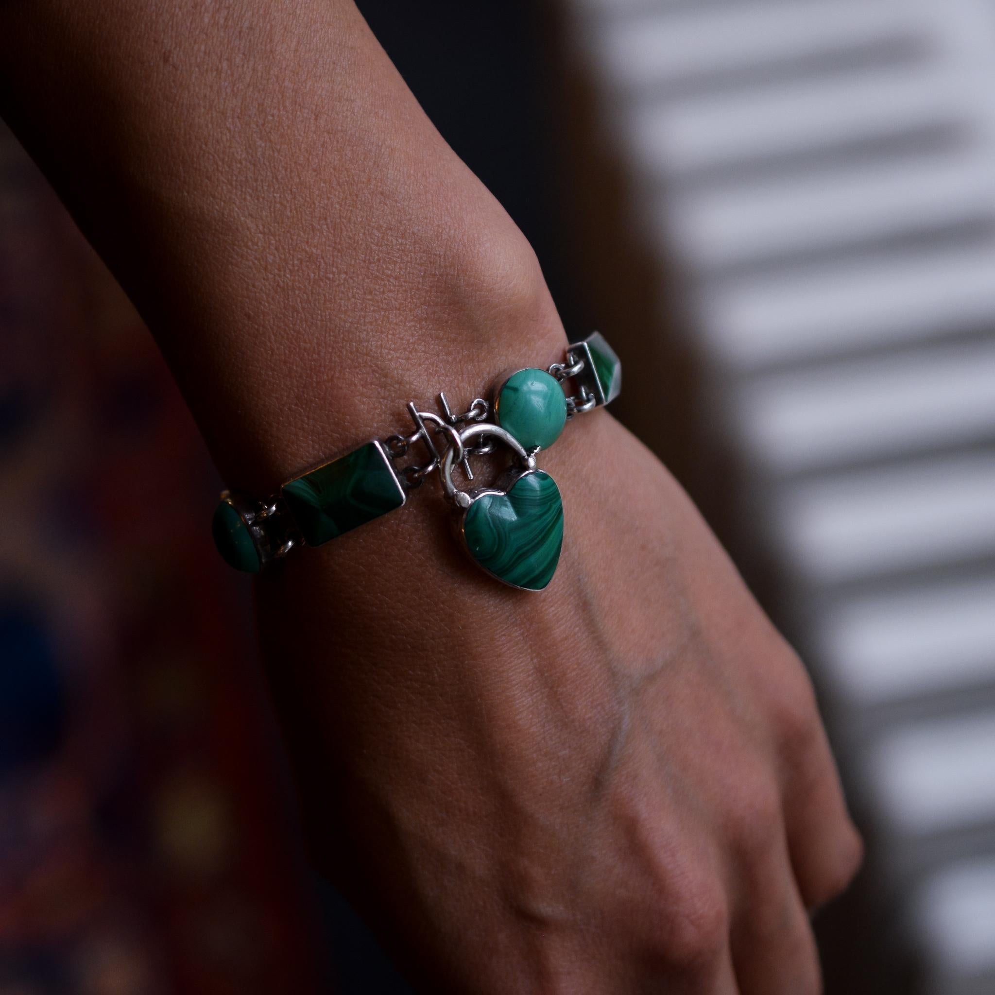 A gorgeous antique Scottish bracelet with heart padlock clasp and featuring shaped malachite panels - alternating rectangles and circles. It's modelled in silver, with beautiful chased detailing to the clasp. Dates from circa 1880

STONES