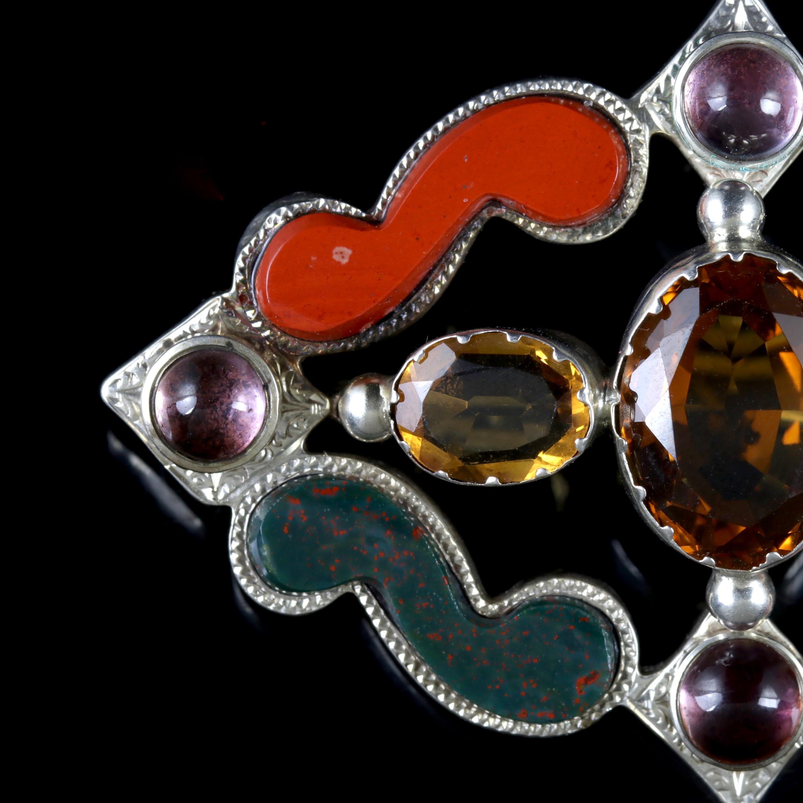 This fabulous Sterling Silver Scottish Agate Victorian brooch is Circa 1860.

Set with Citrine’s in the centre, with beautiful Agates and Quartz surrounding them.

Citrine’s sparkle and have a crisp, radiant quality about them. The name Citrine is