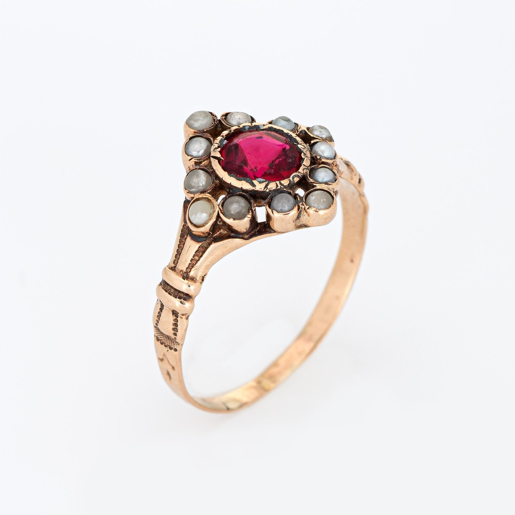 Finely detailed antique Victorian seed pearl and red paste ring (circa 1880s to 1900s), crafted in 10 karat rose gold. 

Red paste stone measures 5mm diameter, accented with 12 x 1.5mm seed pearls. Note: light surface abrasions to the red stone. 