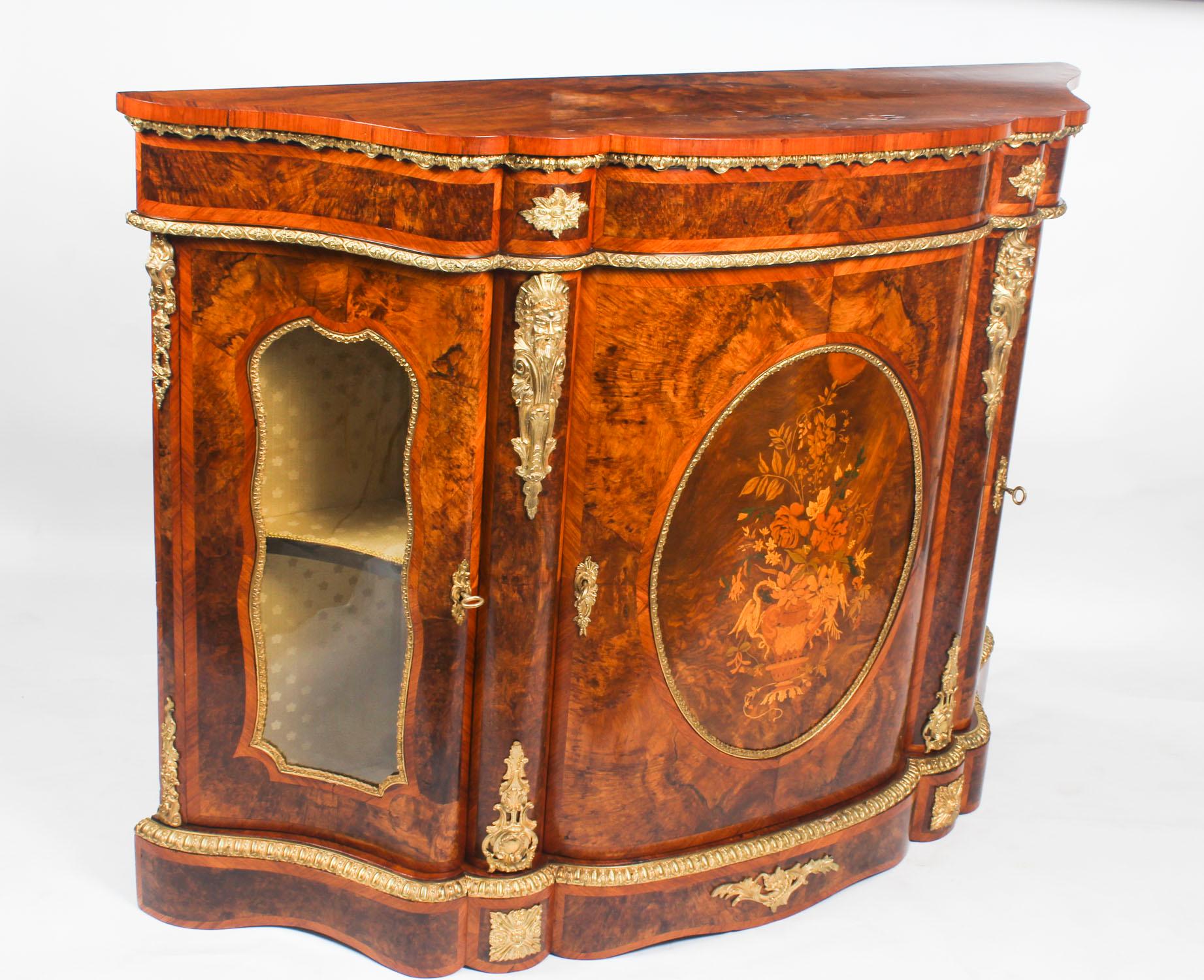 This is an exceptional quality antique Victorian ormolu mounted burr walnut and floral marquetry inlaid credenza, circa 1860.

Oozing sophistication and charm, this credenza is the absolute epitome of Victorian high society.

The entire piece