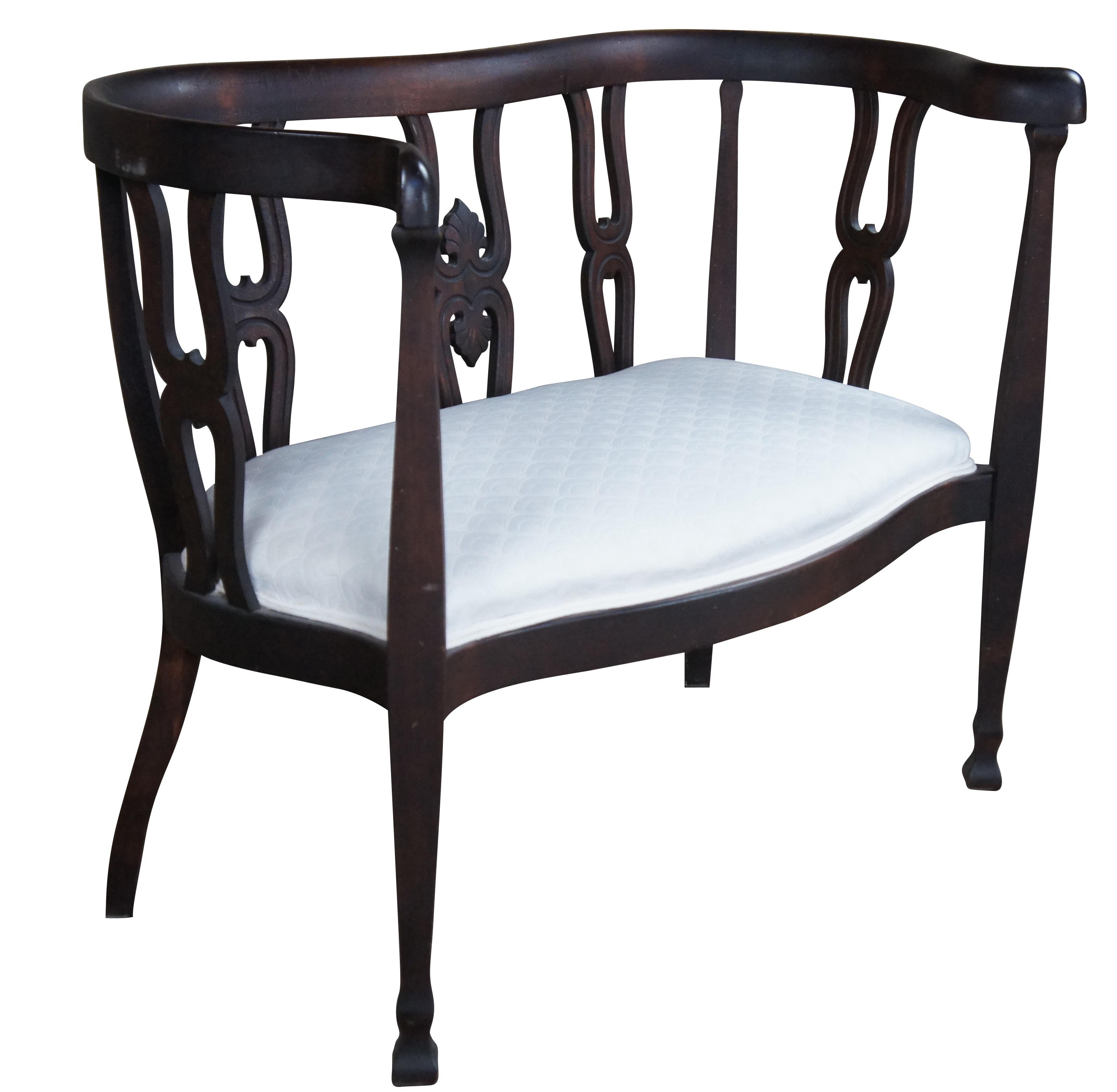 Victorian era serpentine sette or loveseat, attributed to Hersee & Co of Buffalo NY.  Features a mahogany frame with curved crest rail over double horshoe shaped back splat with a foliate carved center.  The settee is upholstered in a white oriental