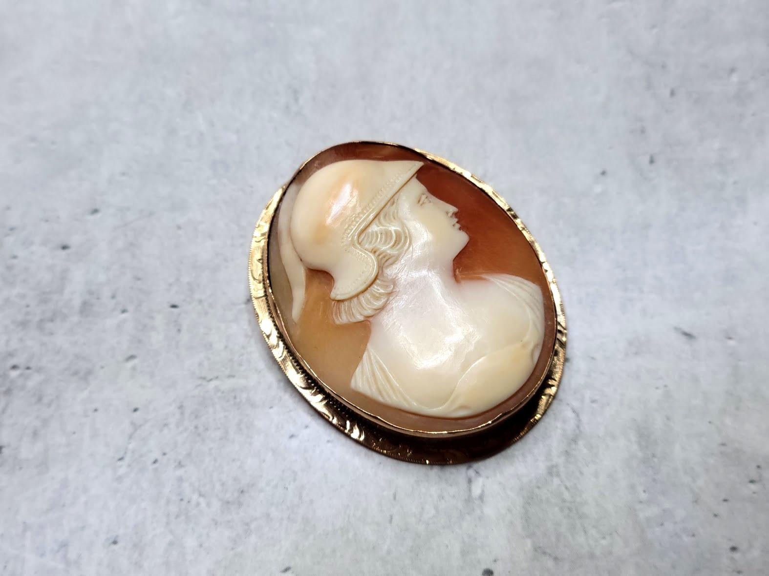 Fabulous carved Victorian brooch made around the late 1800s. The execution of the shell is amazing, and the relief helps to add details and dimension to the design. The frame is 10K yellow gold (on the reverse side of the cameo, there is a stamp