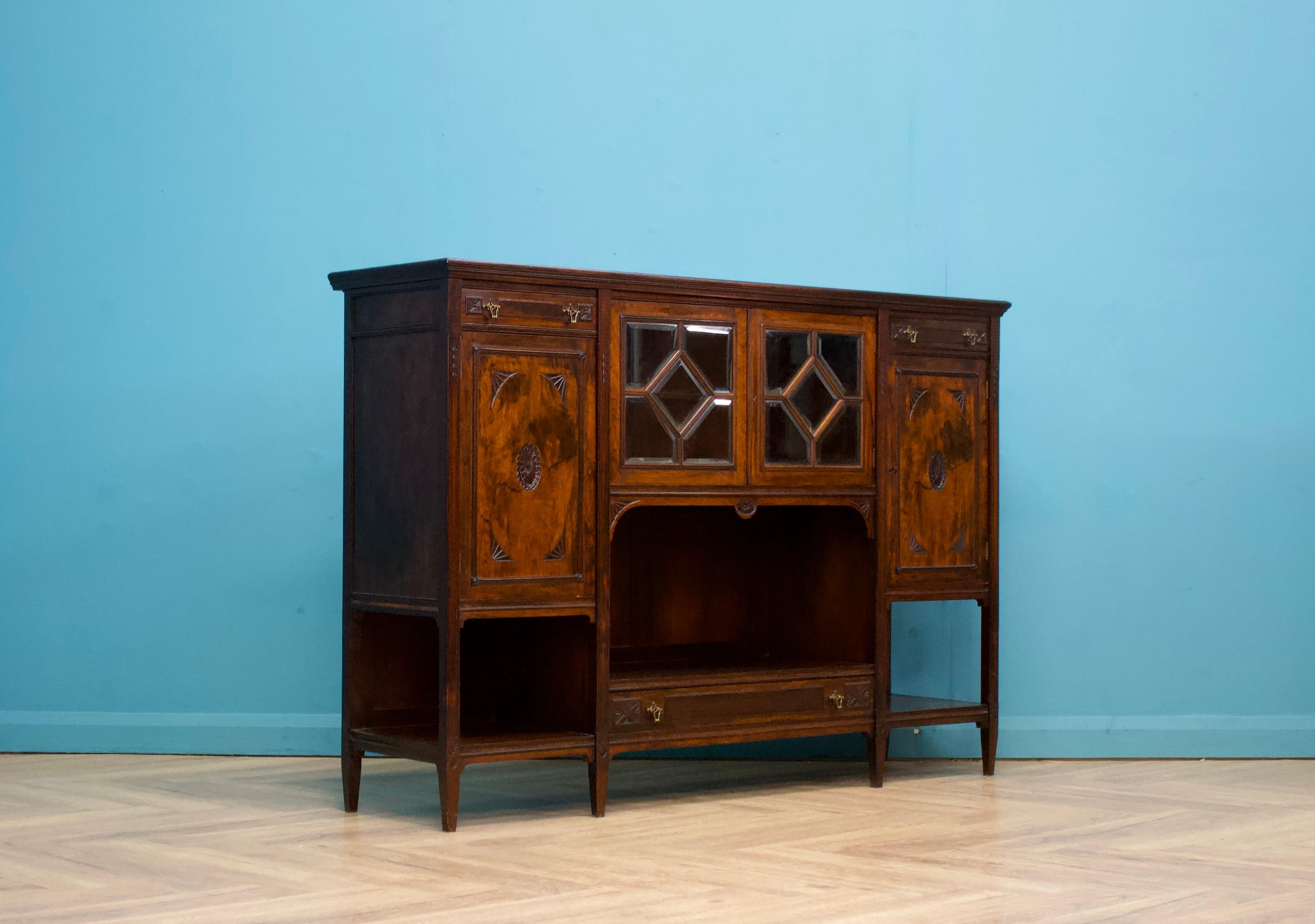 This high-quality Victorian sideboard, circa 1980s, features three lockable cupboards and three drawers. There are also three shelves for additional storage or display.