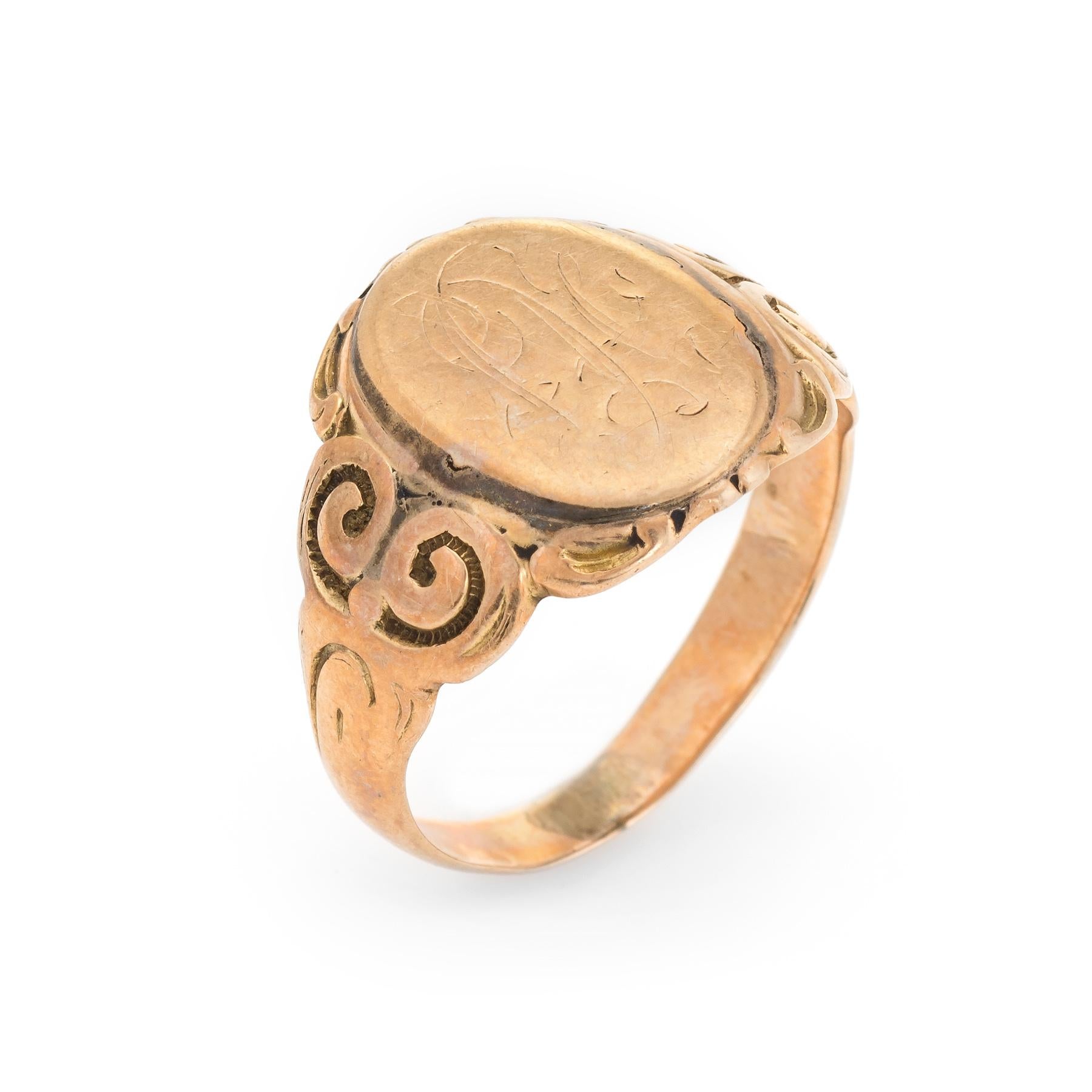 Lovely antique Victorian signet ring (circa 1880s to 1900s), crafted in 10 karat rose gold. 

The center oval is inscribed yet due to wear we are unable to decipher the letters. 

The side shoulders feature a pretty swirling design that terminates