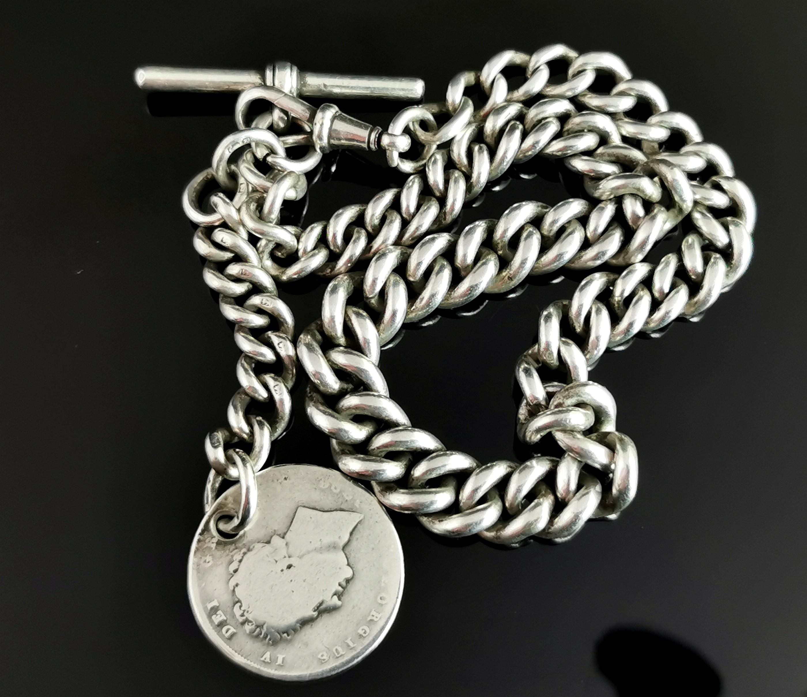 An attractive antique, Victorian era, sterling silver Albert chain or watch chain.

Nice chunky graduated curb links with a dog clip fastener to one end and a sterling silver t bar.

The chain has a short extension with an antique George IV 1826
