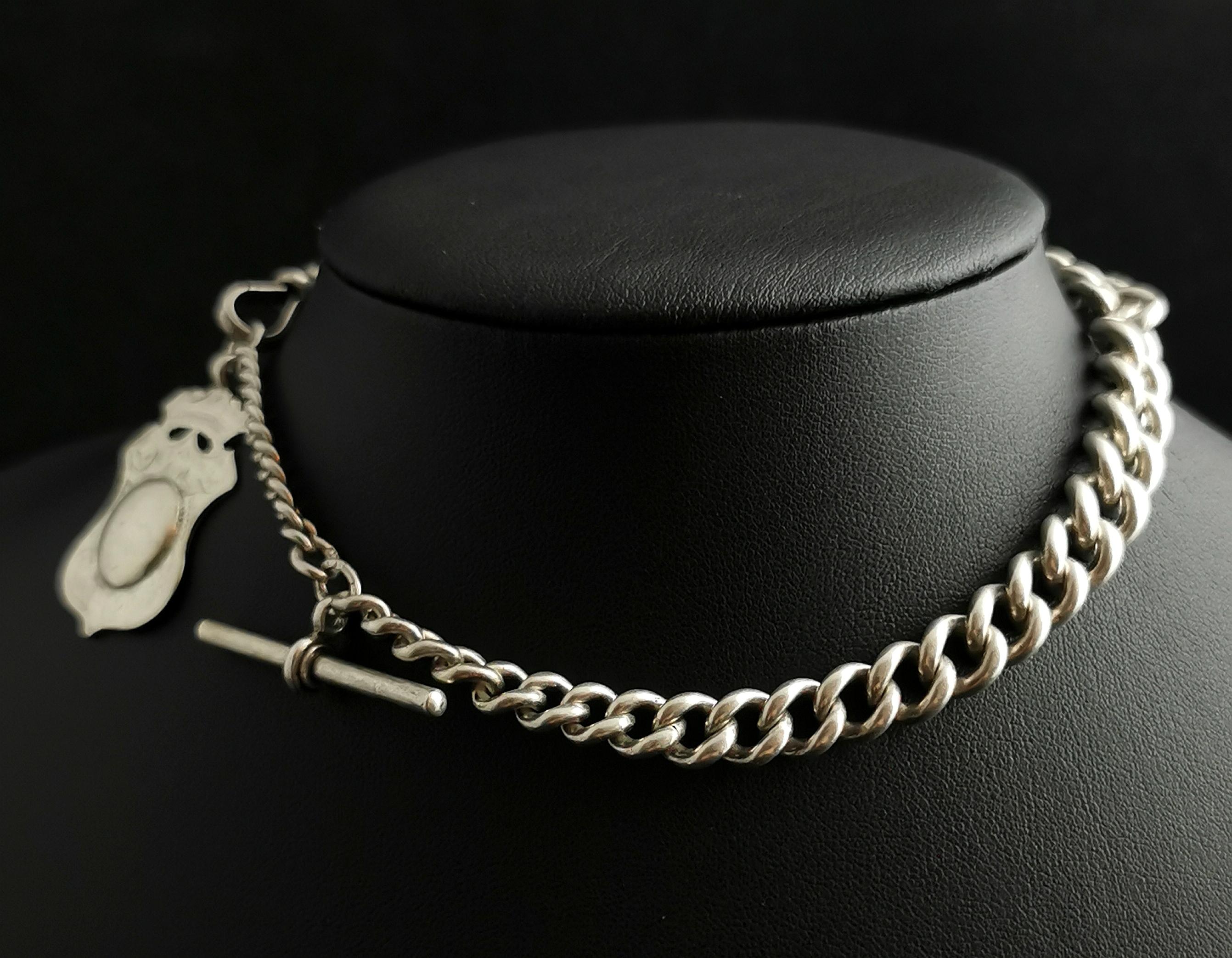 An attractive antique, Victorian era sterling silver Albert chain or watch chain.

Nice chunky silver,graduated curb links with a dog clip fastener to one end and a Vintage silver fob and t bar.

The chain is made from sterling silver and is